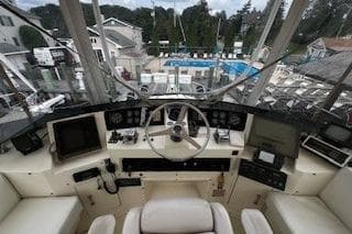 Cockpit view of a 1990 Hatteras 40 Motor Yacht with marina backdrop.
