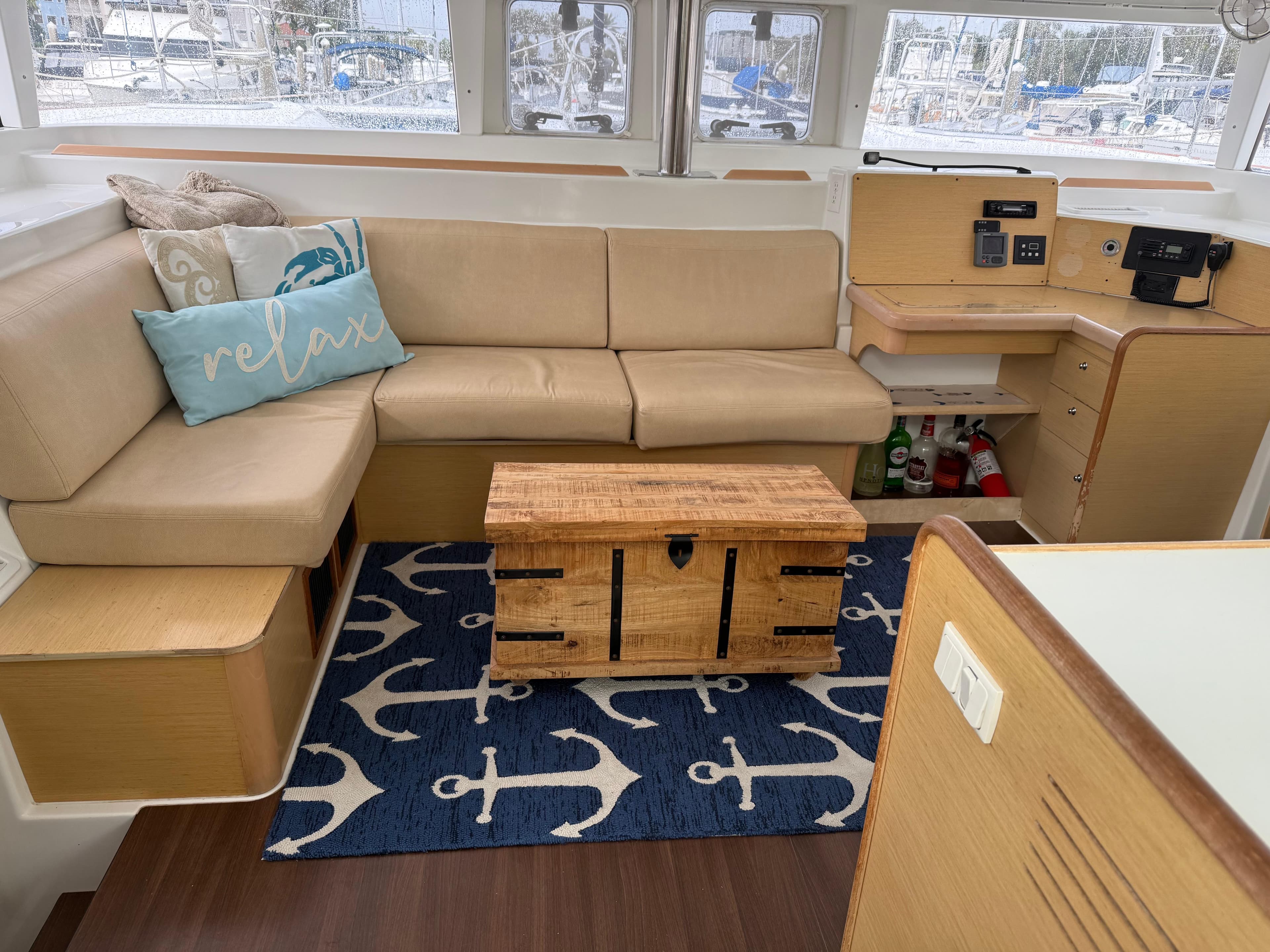Interior of 2010 Lagoon 400 yacht with beige seating, nautical decor, and wooden accents.