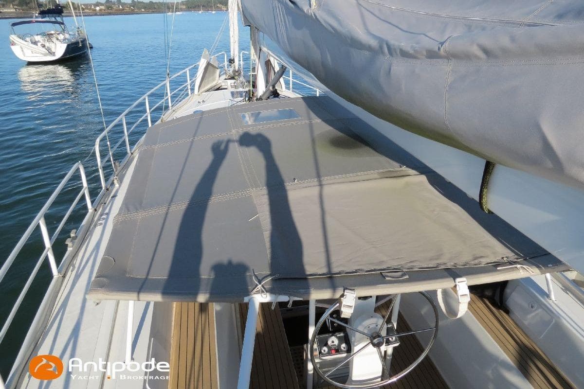 Sailboat deck with steering wheel, shadows, and water view; Meta JPB 52, 2021 model.