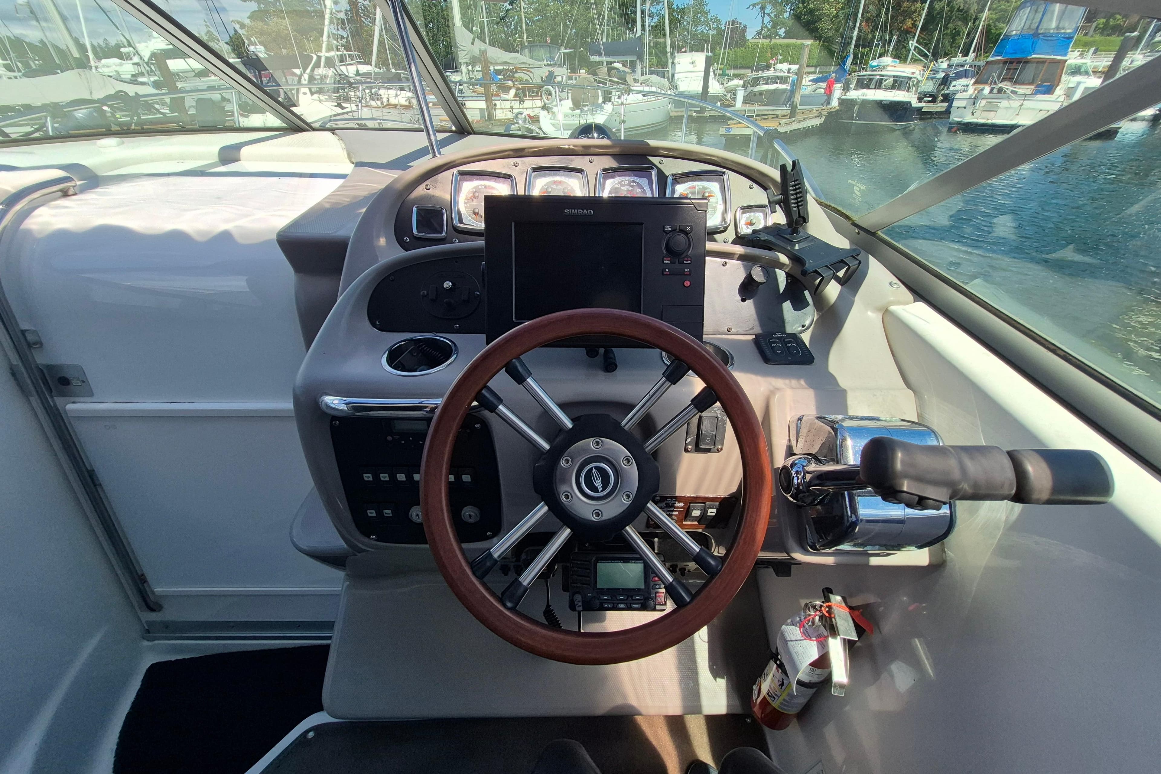 2008 Chaparral Signature 280 helm with steering wheel, controls, and navigation equipment.