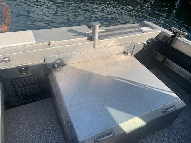 EagleCraft Workboat 1994, metal deck and storage, docked on calm water.