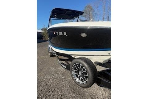 2018 Cobalt A28 boat on trailer, black and white design, parked outdoors.