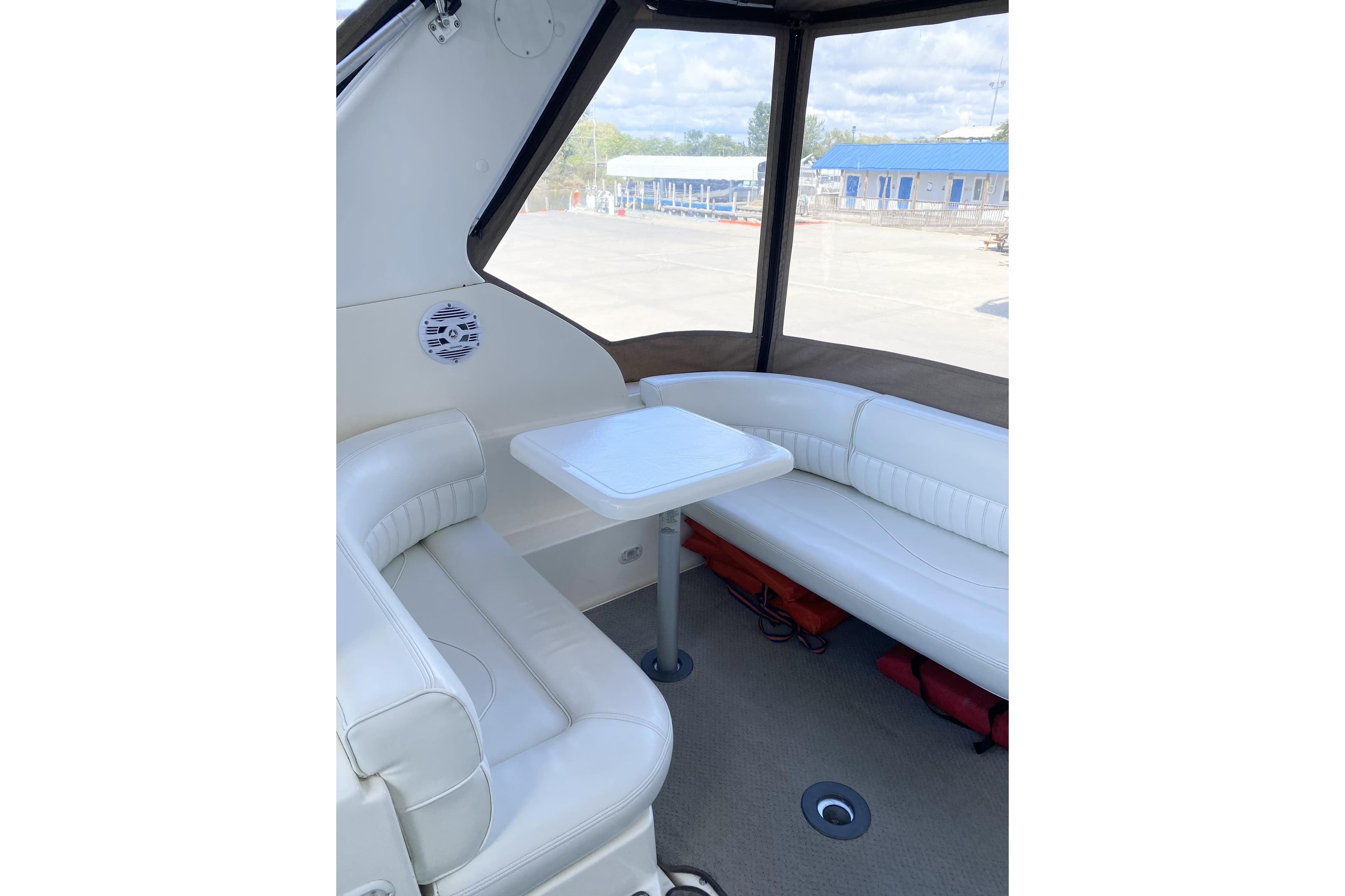 2003 Cruisers Yachts 2870 Express interior with white seating and table.