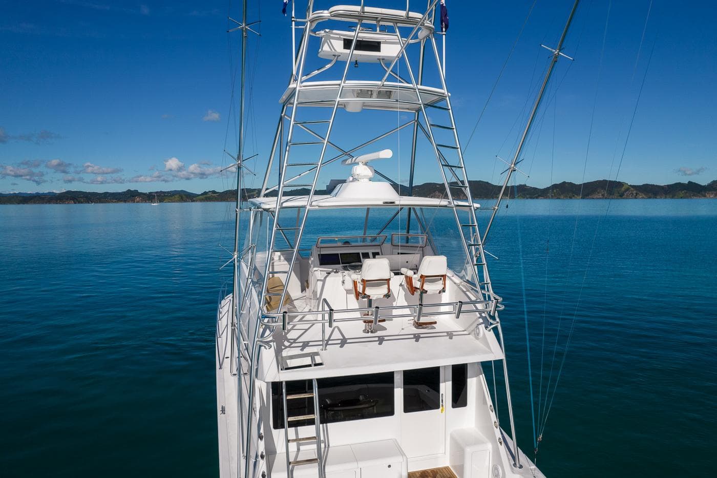 2002 Viking 55 Convertible yacht on calm blue waters with scenic island backdrop.