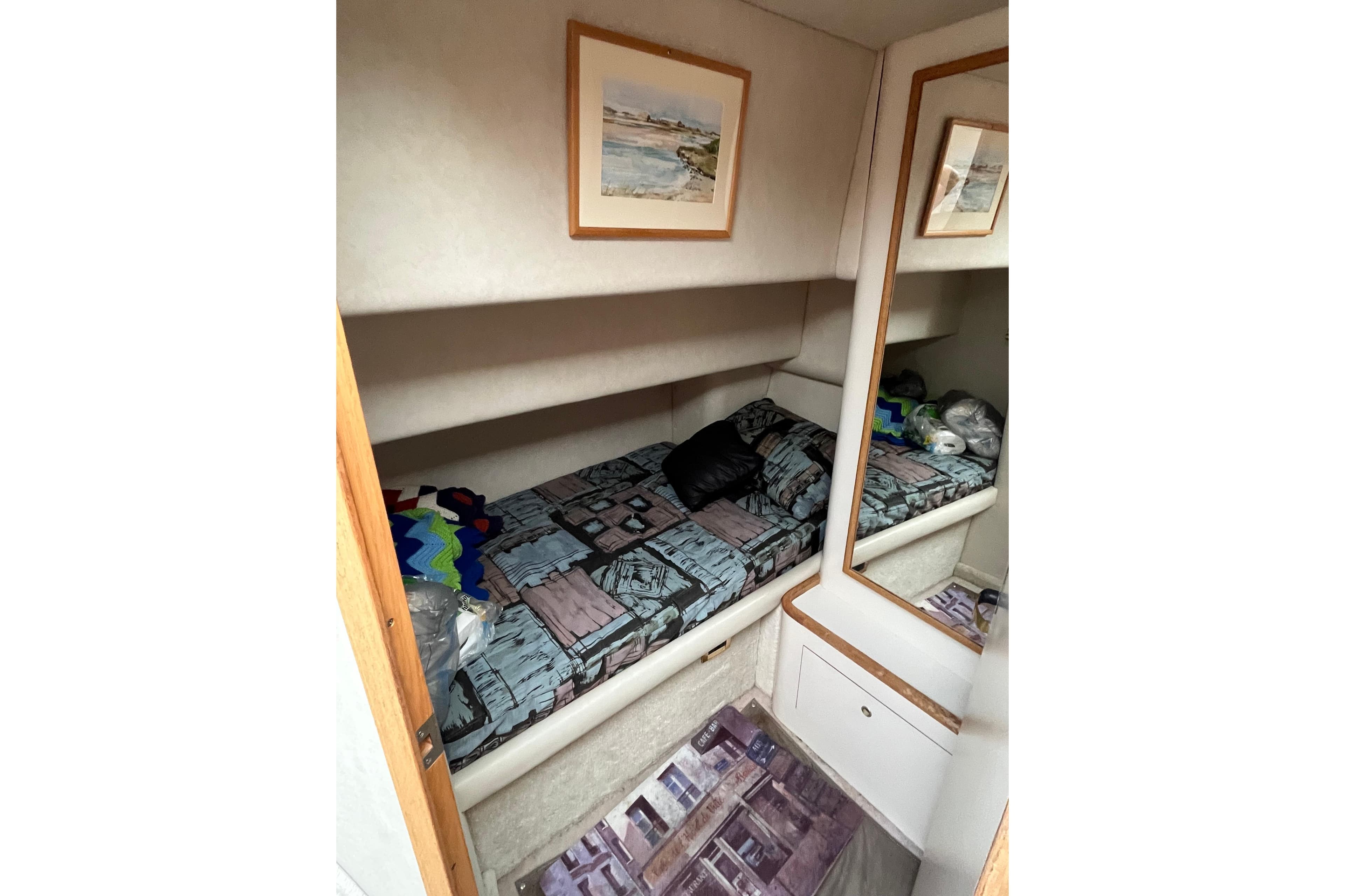 1997 Sea Ray 420 Aft Cabin interior with cozy bed and mirror.