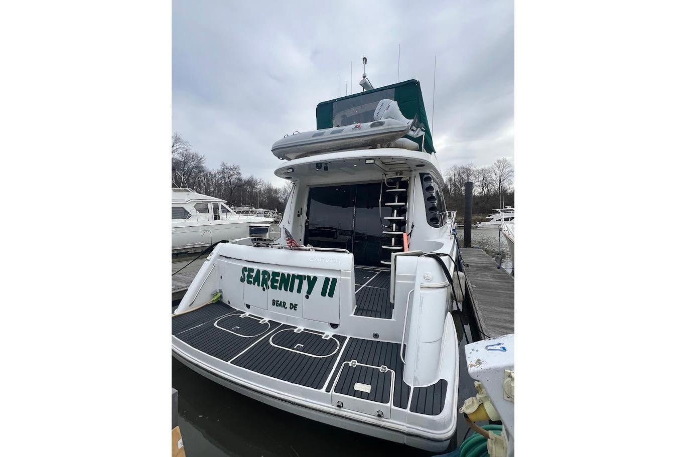2000 Carver 530 Voyager Pilothouse yacht docked, rear view with "SEARENITY II" name.