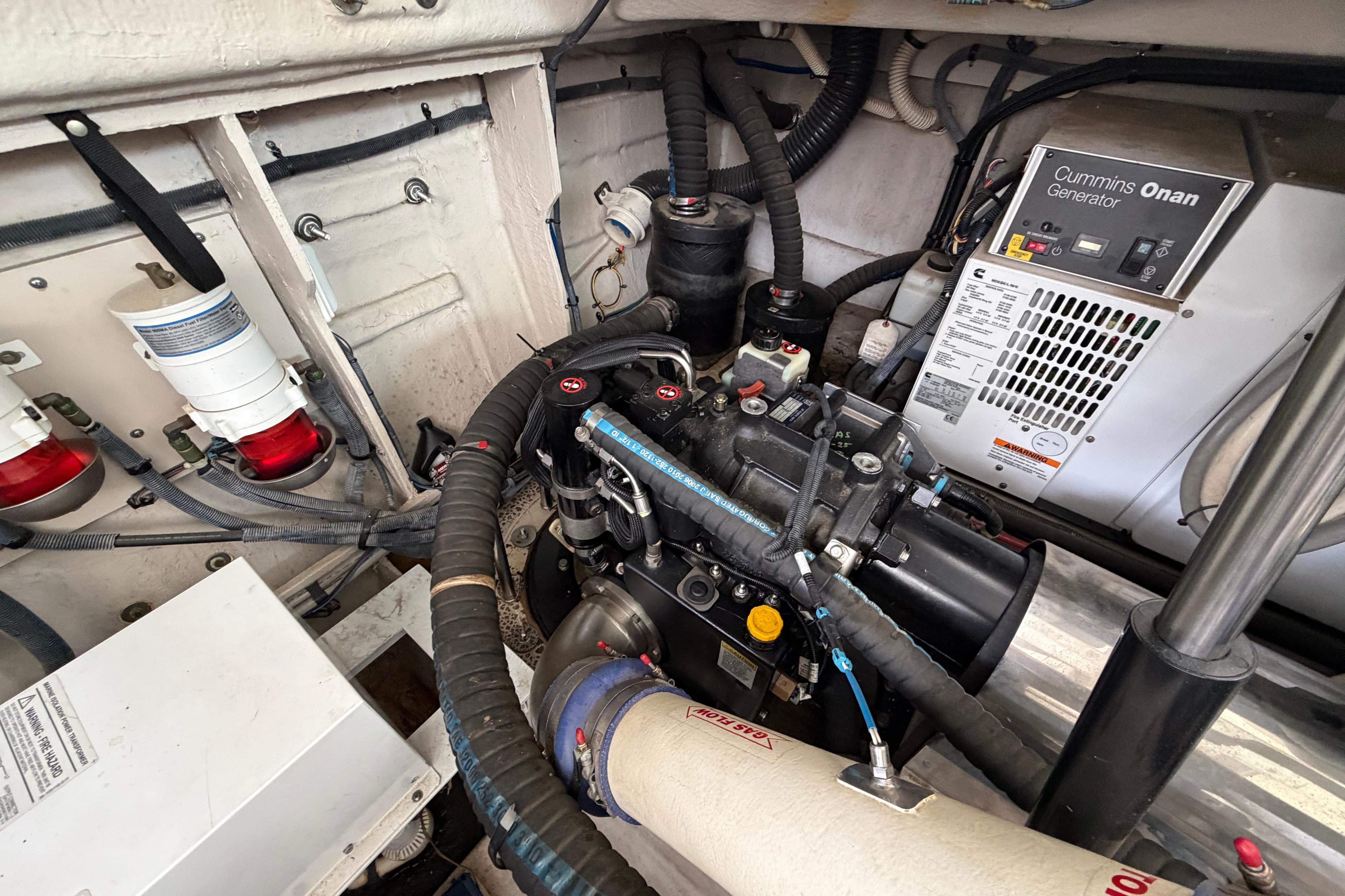 Engine room of 2012 Sea Ray 450 Sundancer with Cummins Onan generator and various components.