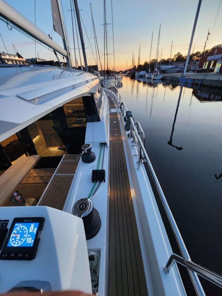 2025 Moody 48 DS yacht docked at sunset, featuring sleek design and modern navigation instruments.