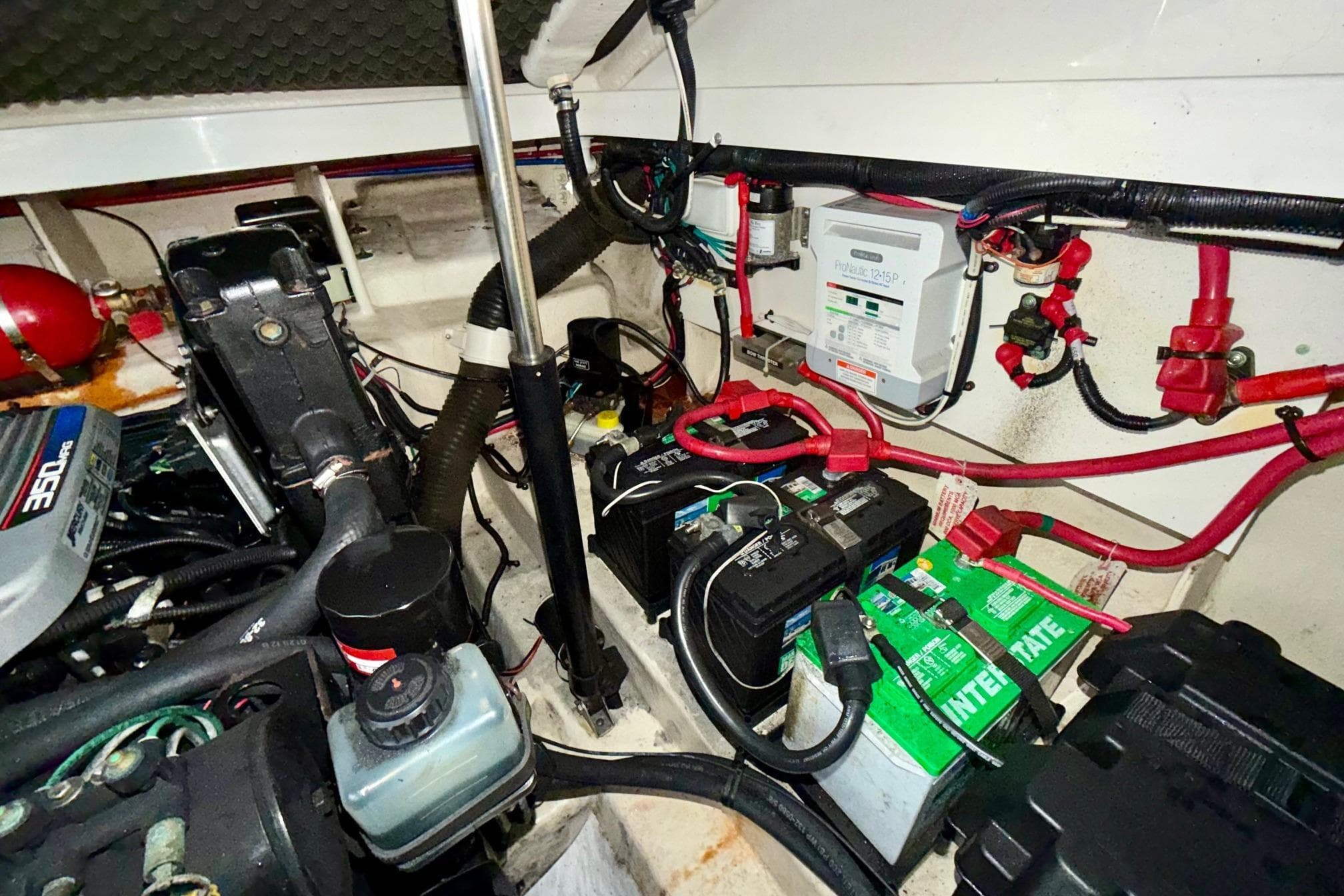 Engine compartment of 2012 Sea Ray Sundancer 280 with batteries and wiring.