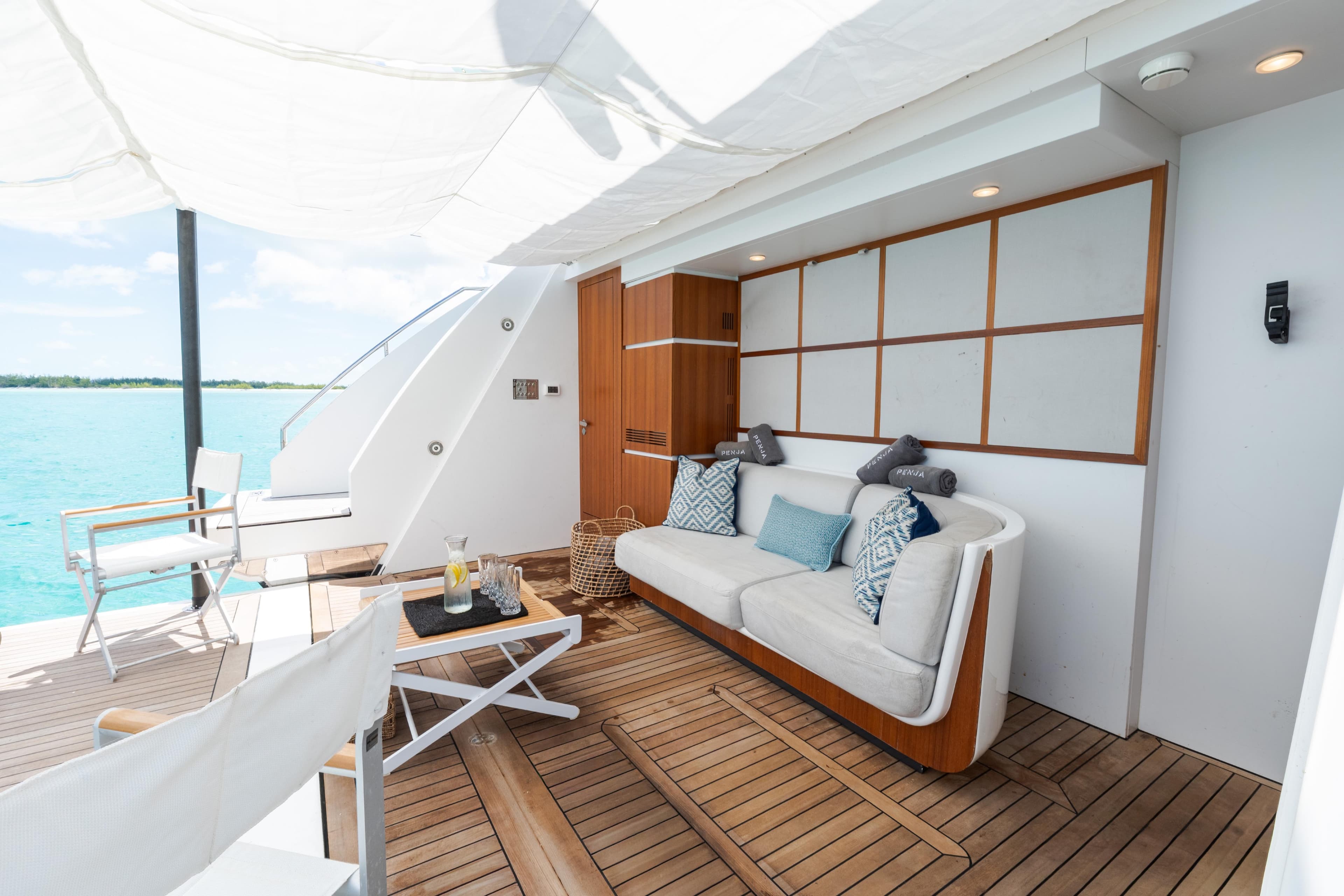 Luxurious deck of 2023 Azimut Grande 32M yacht with elegant seating and ocean view.