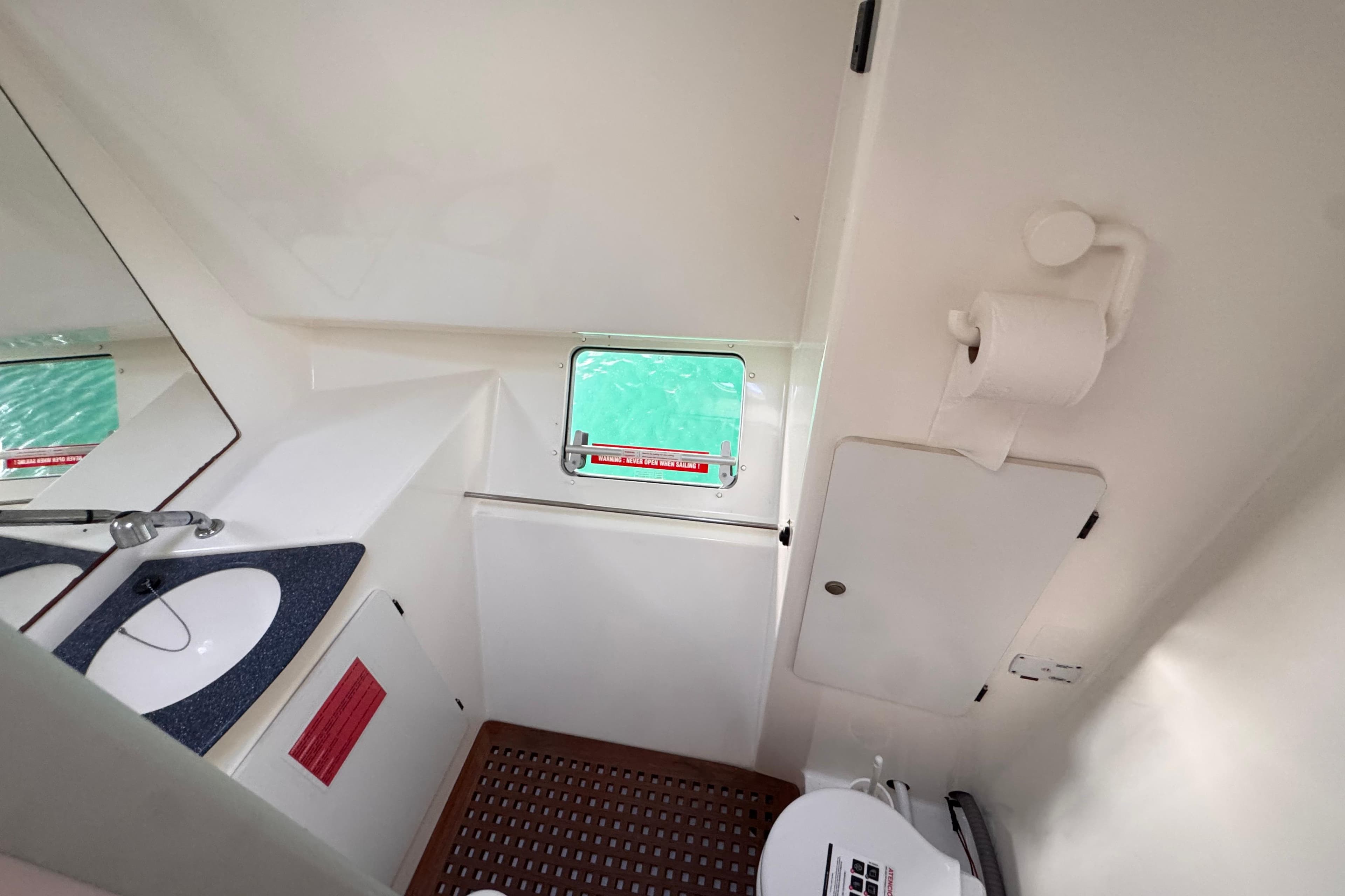 Bathroom interior of 2003 Fountaine Pajot Belize 43 catamaran, featuring sink and toilet.