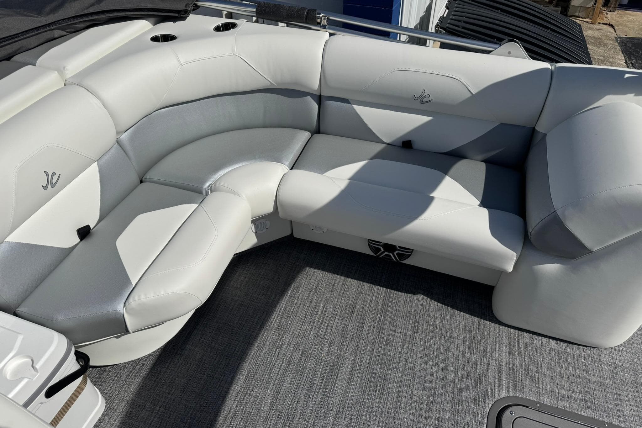 Luxurious seating on 2026 JC Spirit 222 TT Sport boat, featuring sleek white upholstery.