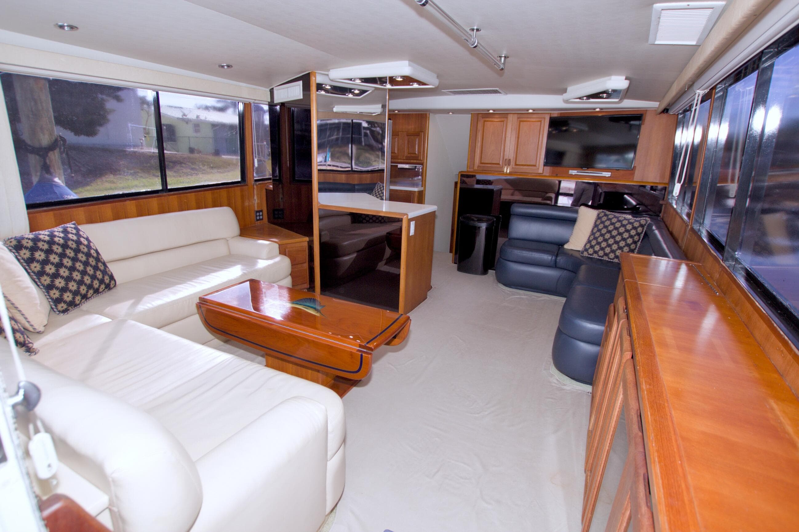 Luxurious interior of a 1990 Viking 53 Convertible yacht with elegant seating and wood finishes.
