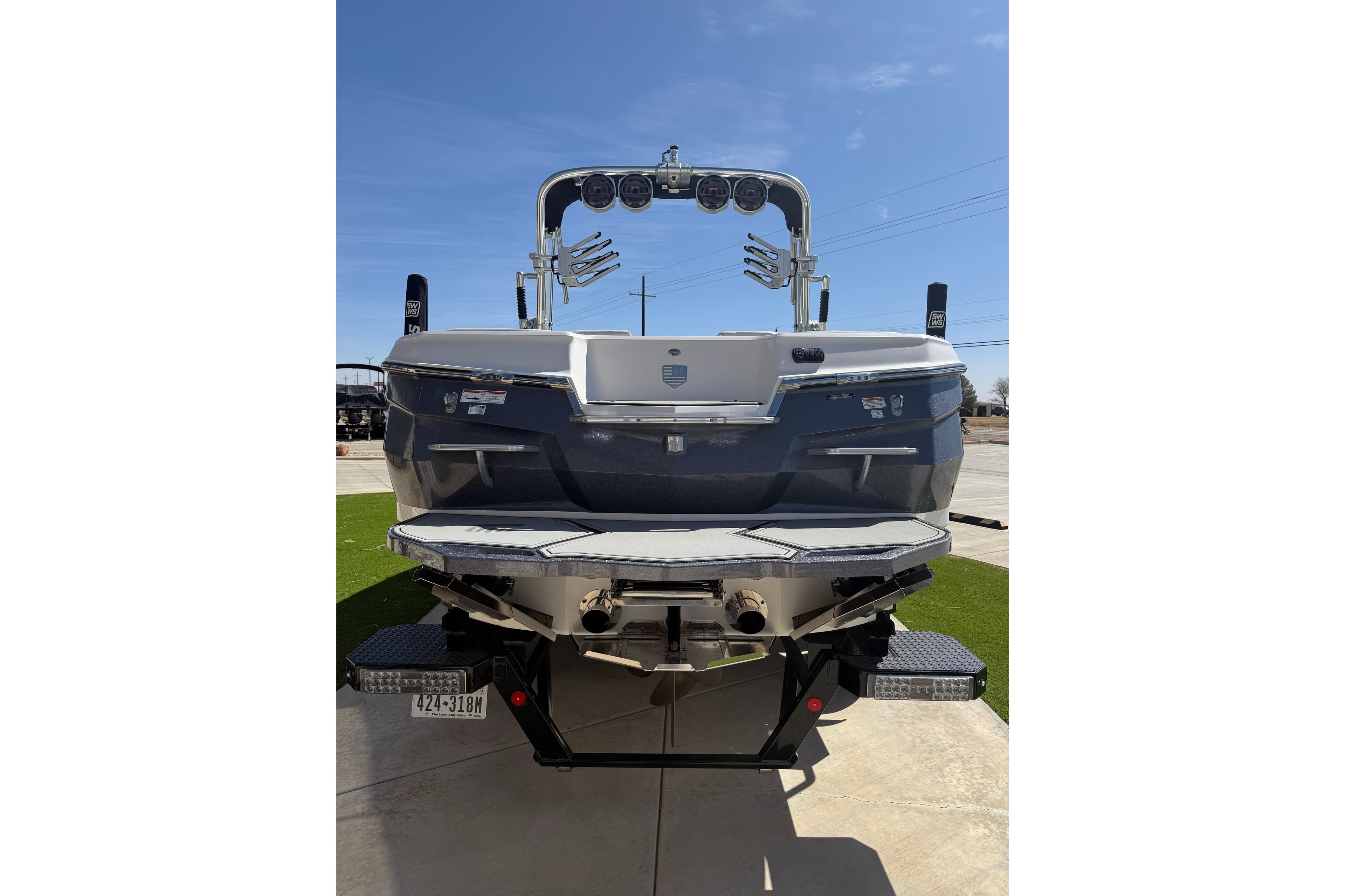 2021 MasterCraft XStar boat rear view with wakeboard tower and swim platform.