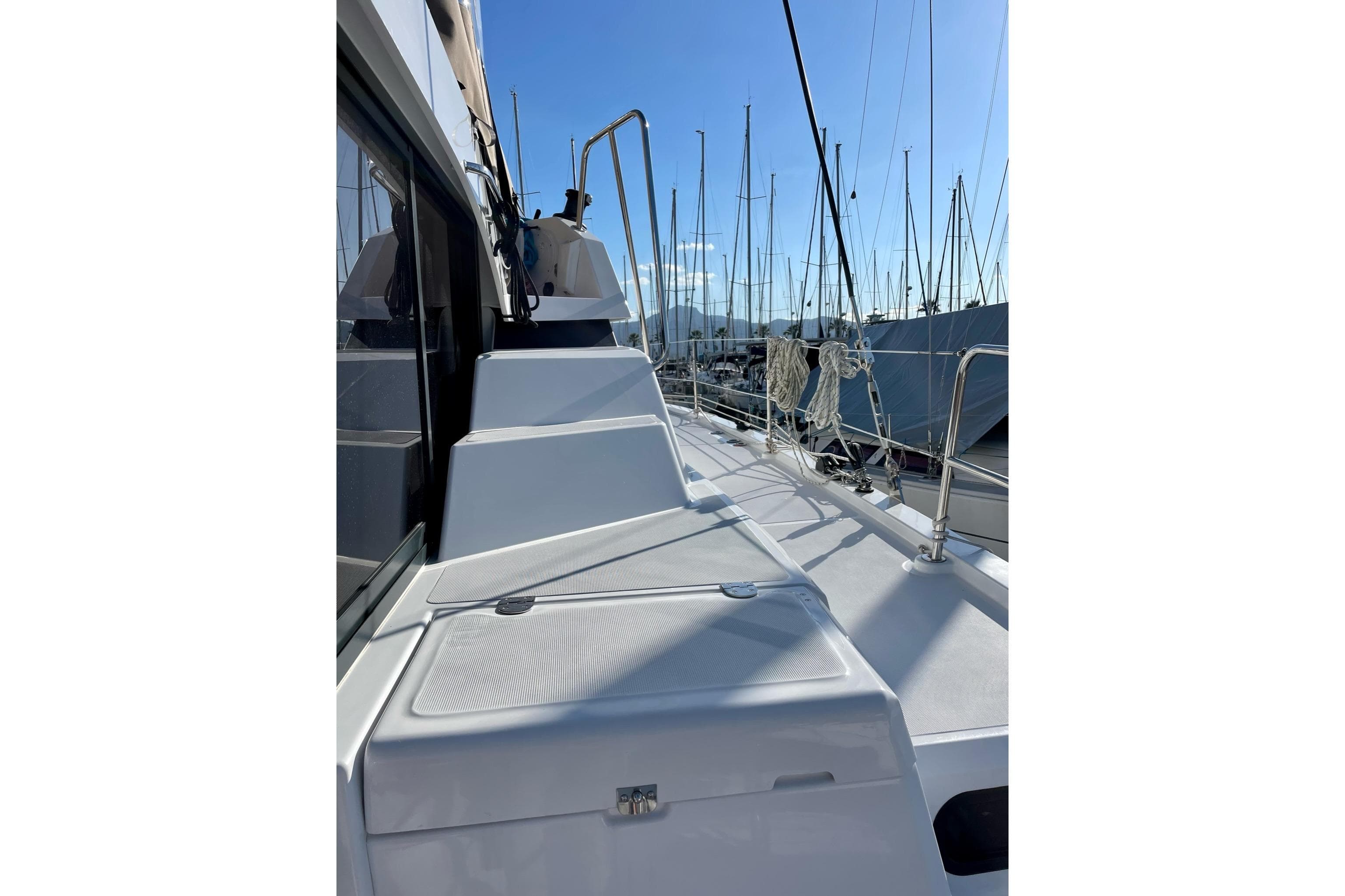 2022 Bali CATSPACE yacht deck with marina view, featuring sleek design and clear blue sky.