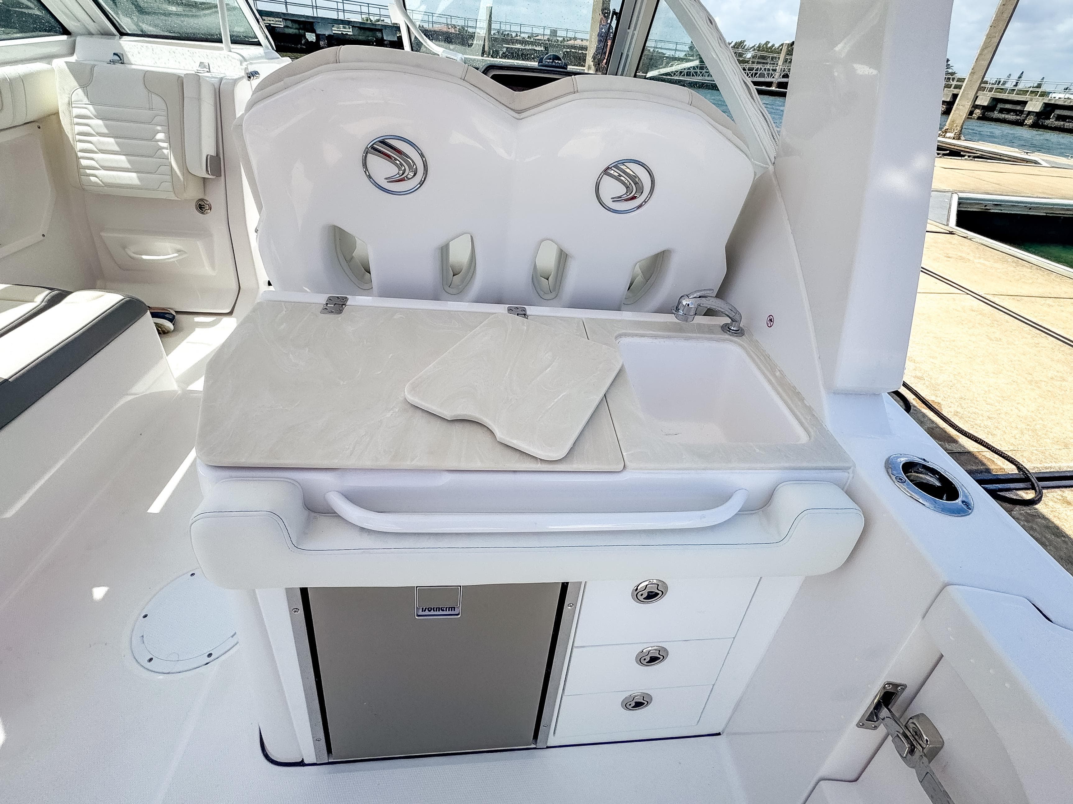 2025 Edgewater 262 CX boat interior with kitchenette, sink, and storage drawers.