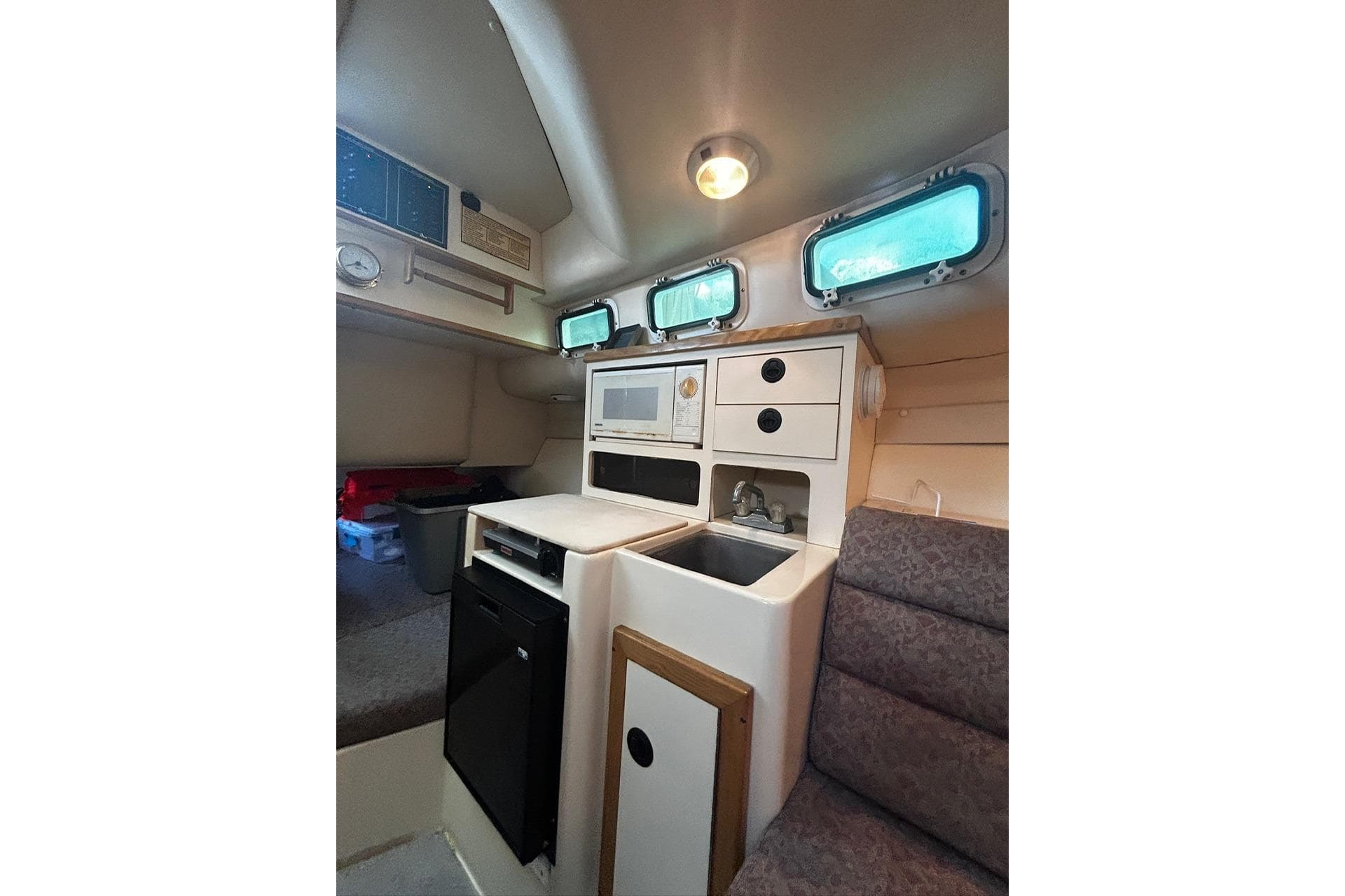 Interior of 2000 Albin 28 Tournament Express with kitchenette and seating area.