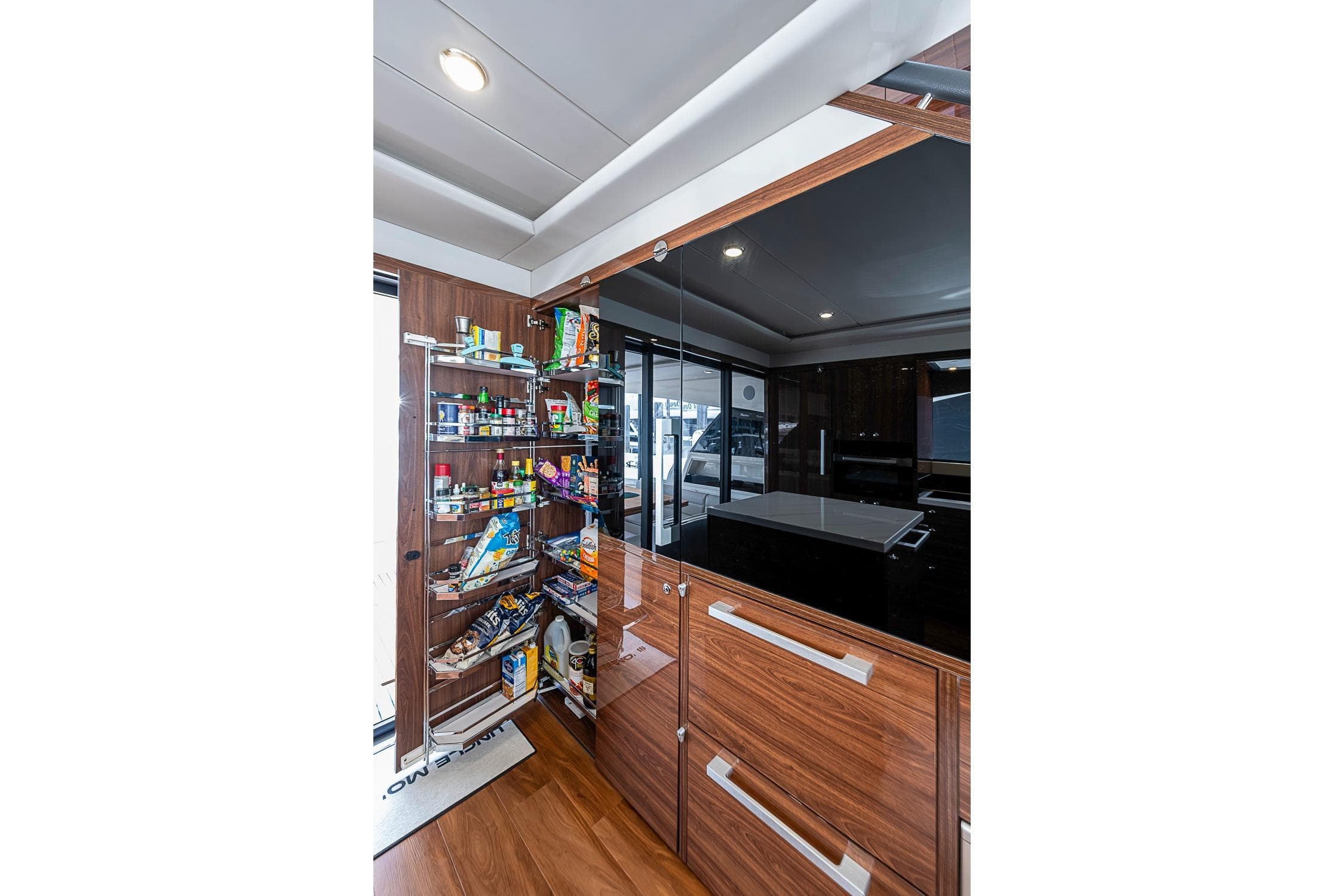 Luxurious Maritimo M75 yacht interior showcasing a modern kitchen pantry, 2025 model.
