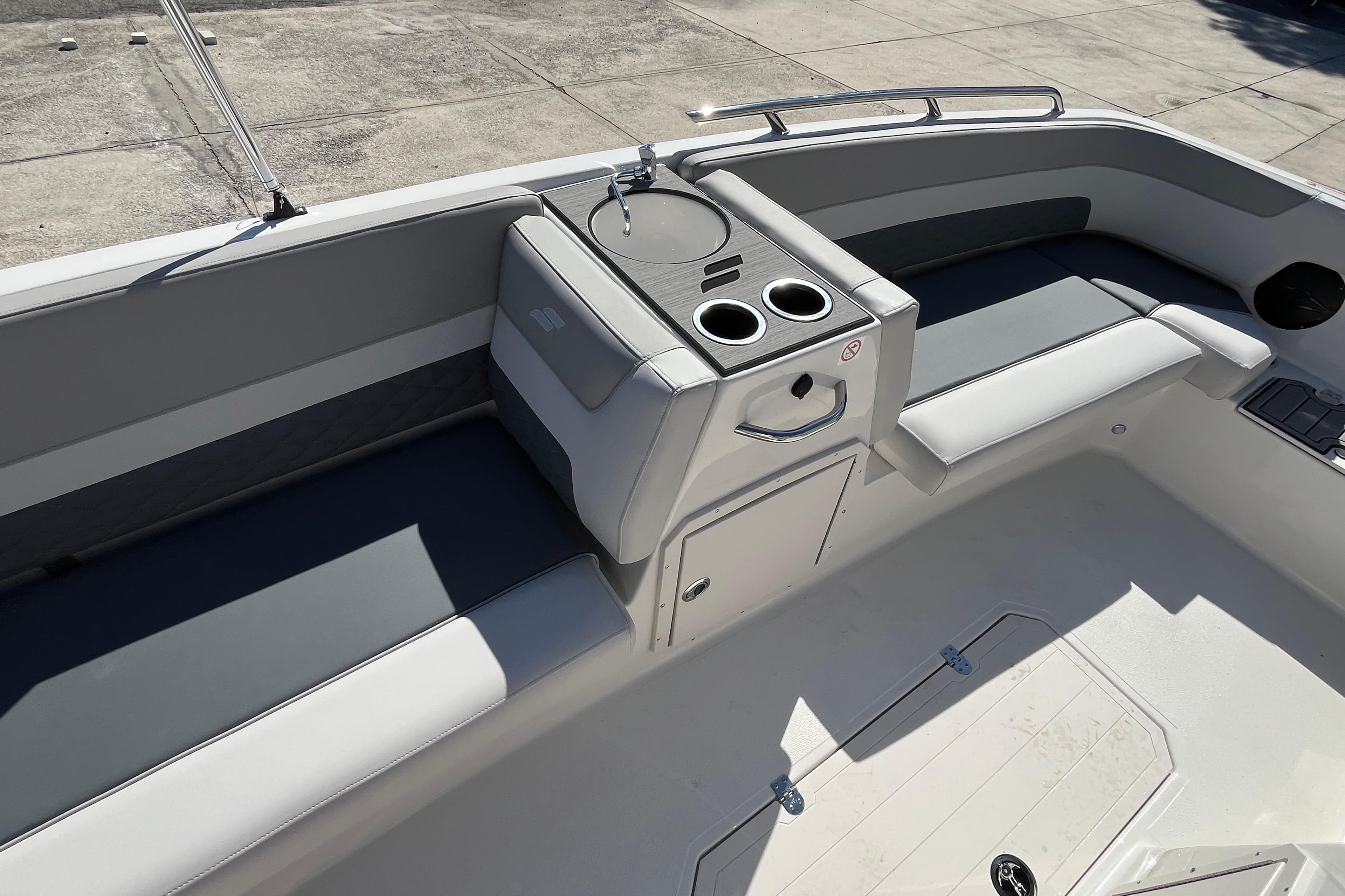 2026 Starcraft SVX 211 OB boat interior with seating and cup holders.