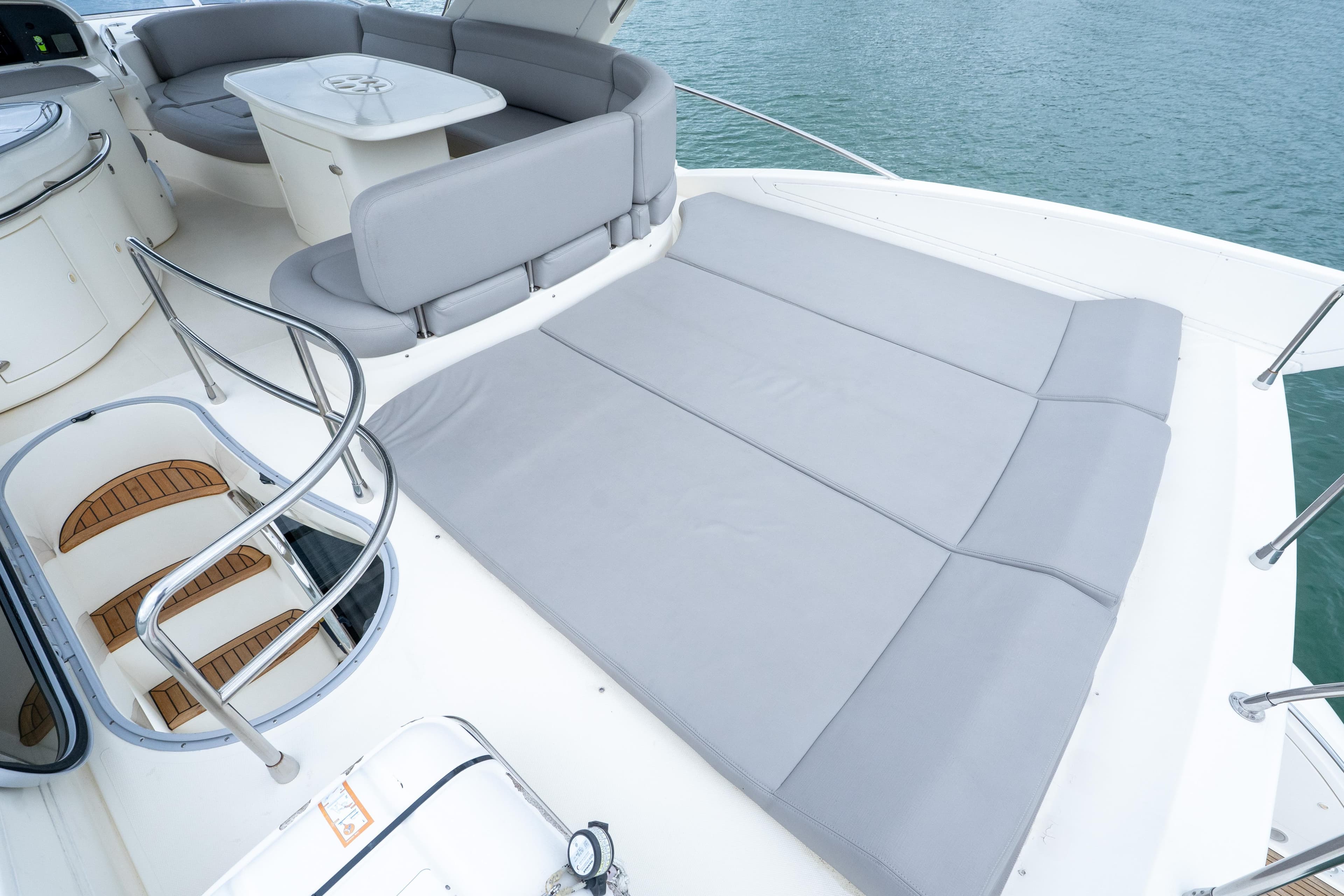 Luxurious 2008 Azimut 62E yacht deck with seating and sunbathing area.