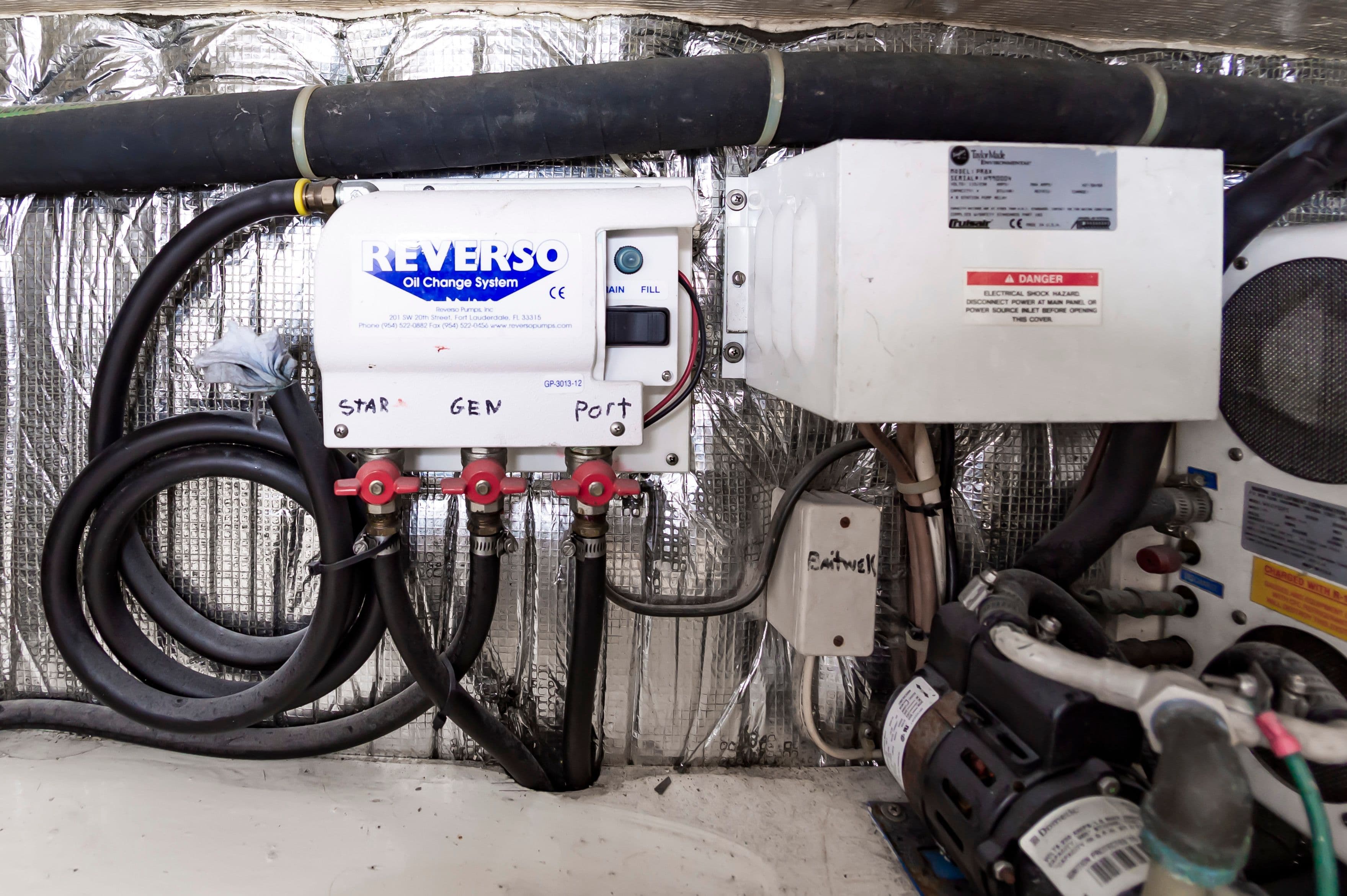 Reverso oil change system in Ocean 48 SuperSport 2000 engine room.