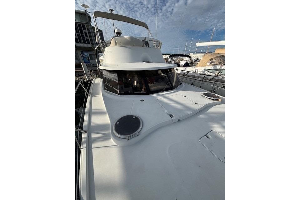 2010 Fountaine Pajot Highland 35 yacht docked at marina under blue sky.