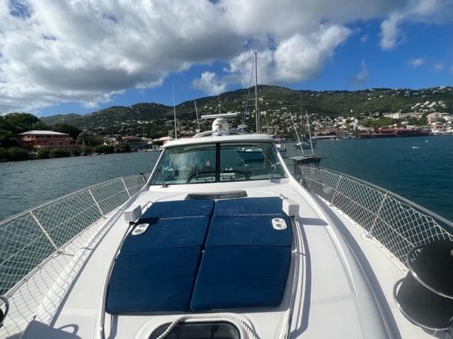 2012 Sea Ray 500 Sundancer yacht on scenic water with hills in the background.
