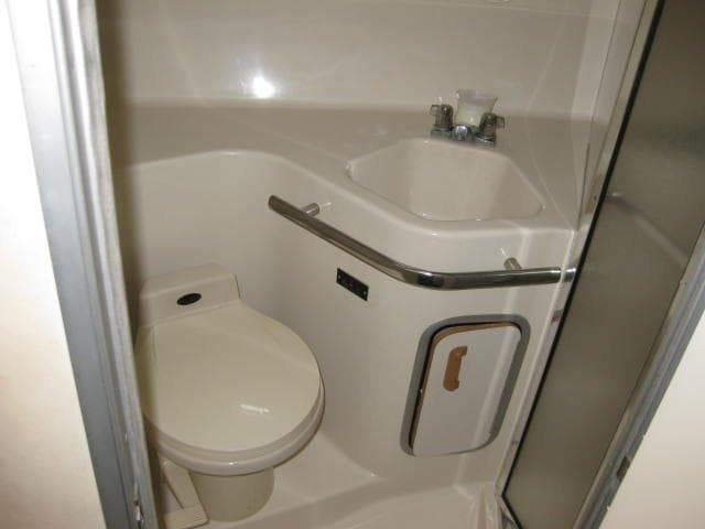 Bathroom interior of 1996 Sea Ray 400 Express Cruiser with toilet and sink.