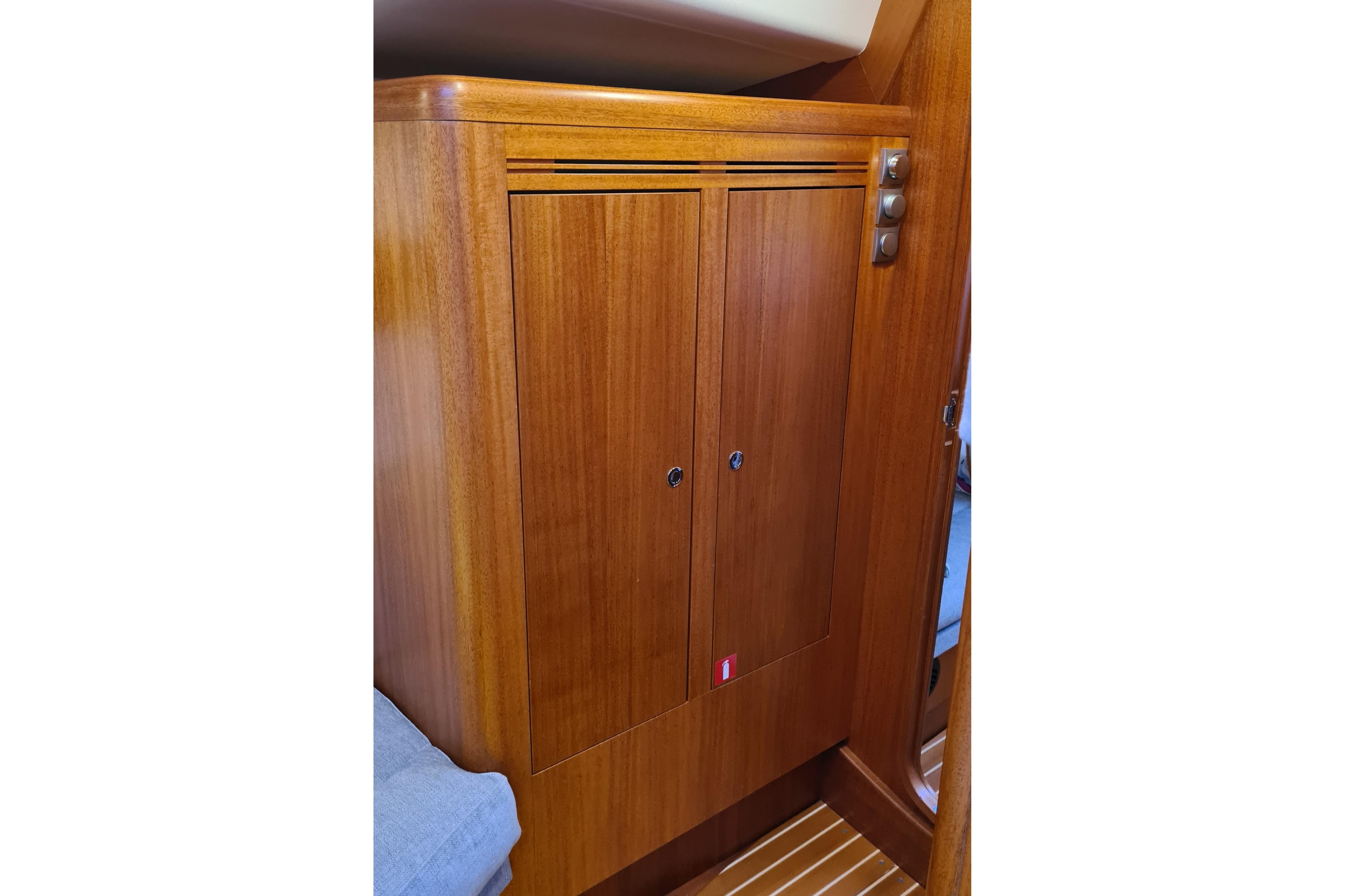 Wooden cabinet interior of 2018 Arcona 435 yacht, featuring sleek design and polished finish.