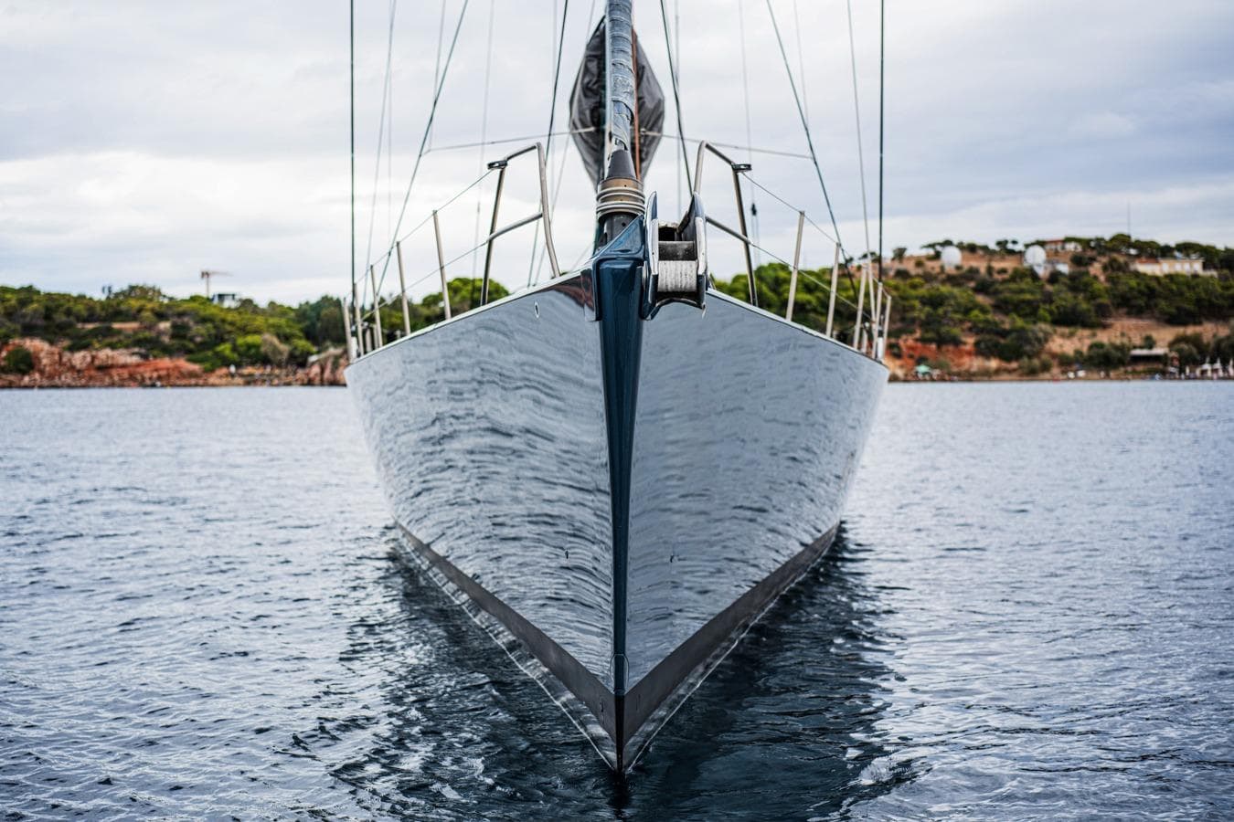 Front view of a 2009 Wally 100 yacht on calm water, with scenic background.