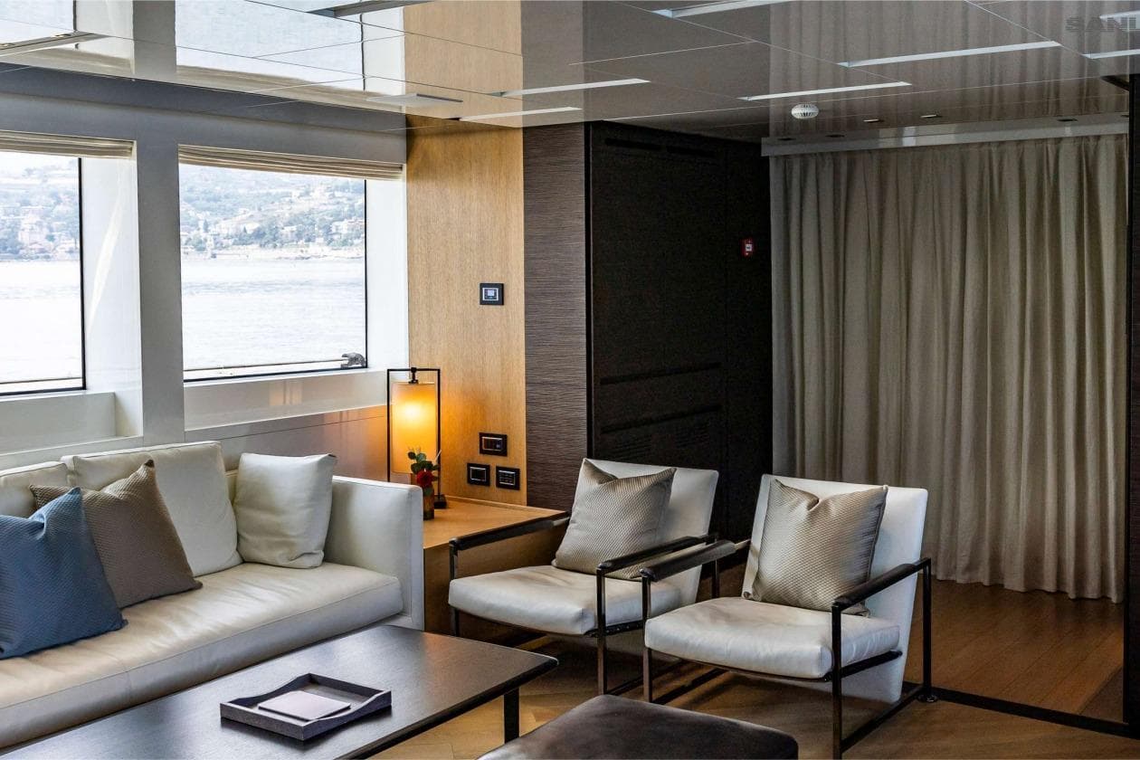 Luxurious interior of 2016 Sanlorenzo SL96 yacht with modern seating and scenic window view.