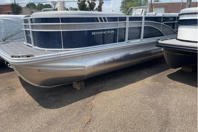 2024 Bennington 22SXSR pontoon boat in a parking lot.