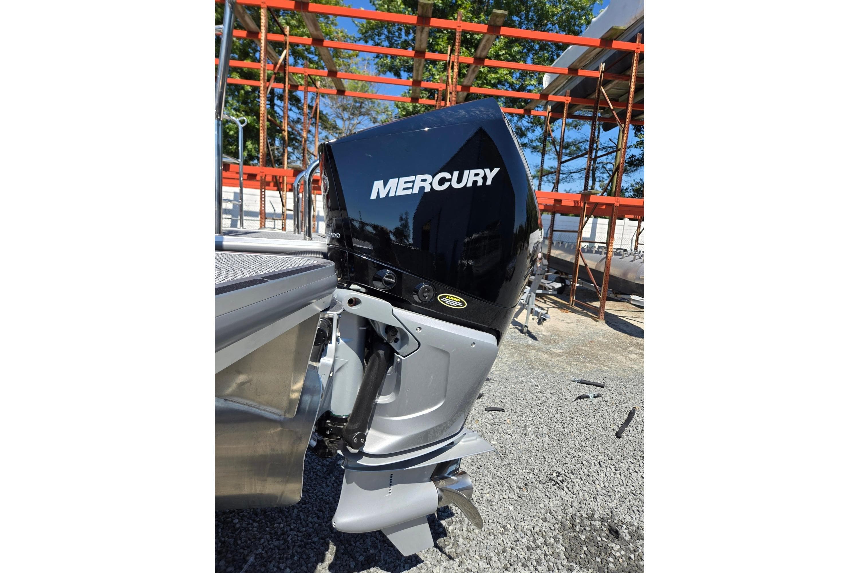 2026 Harris Cruiser 230 with Mercury outboard motor, parked outdoors.