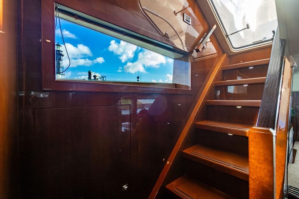 Interior staircase of 2010 Princess 95 Motor Yacht with window view.