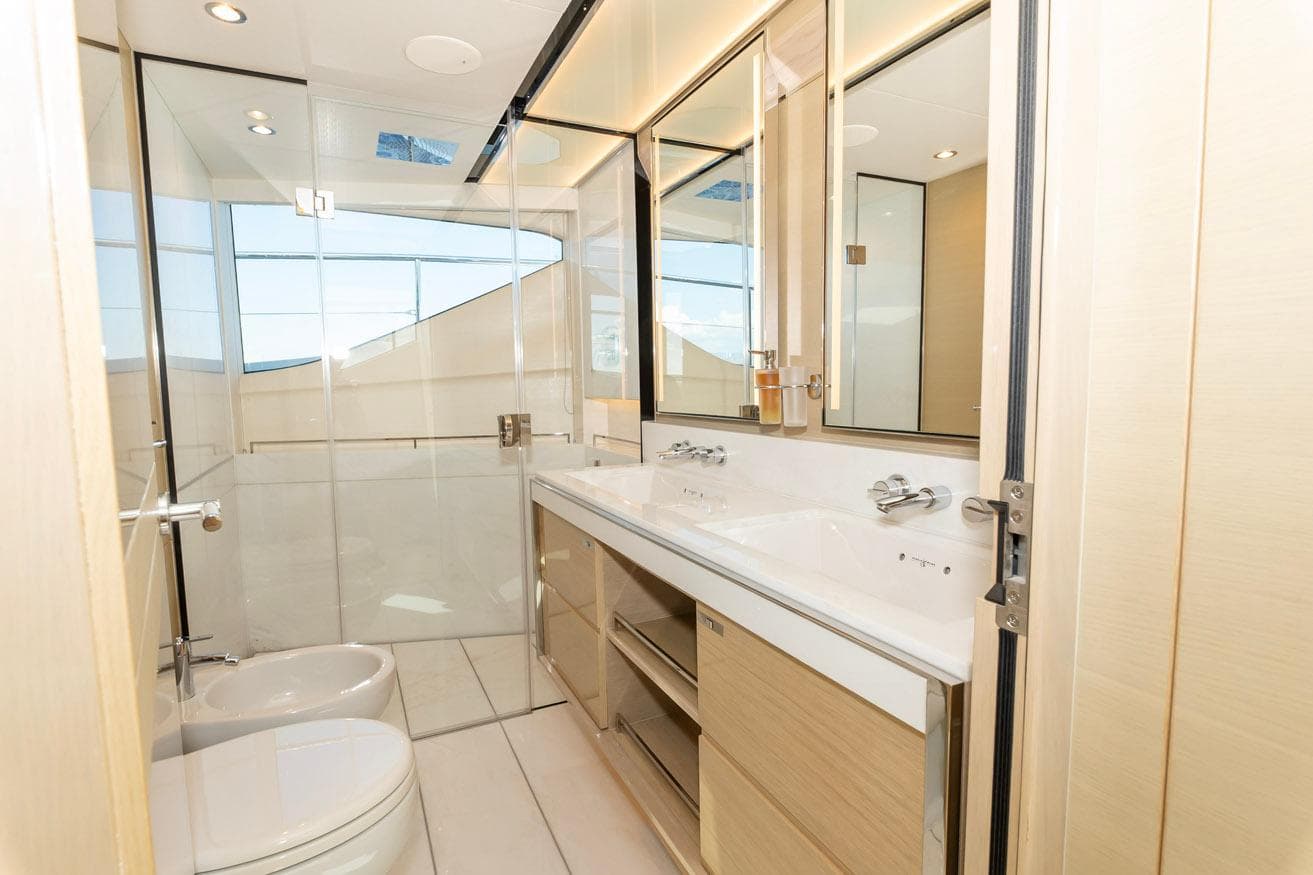 Luxurious bathroom interior on a 2019 Princess 30M yacht, featuring modern fixtures and ample lighting.