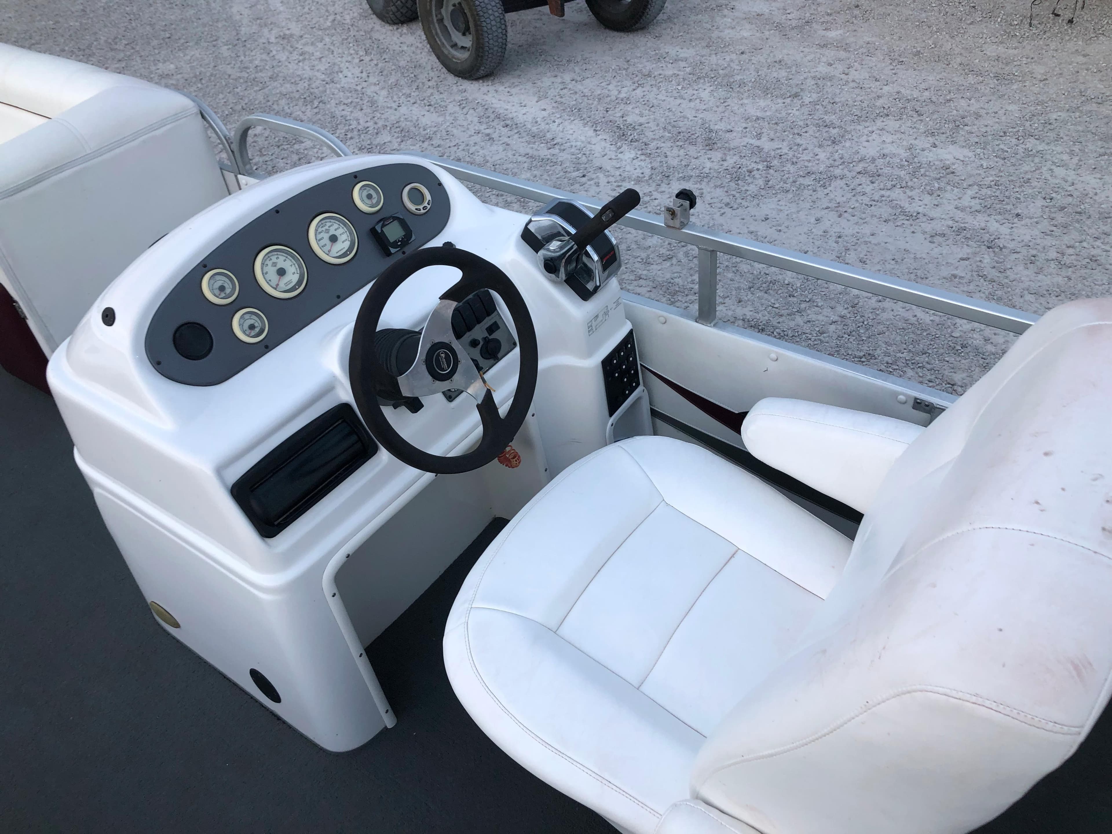 2008 PlayCraft 2600 Clipper boat dashboard and captain's chair.