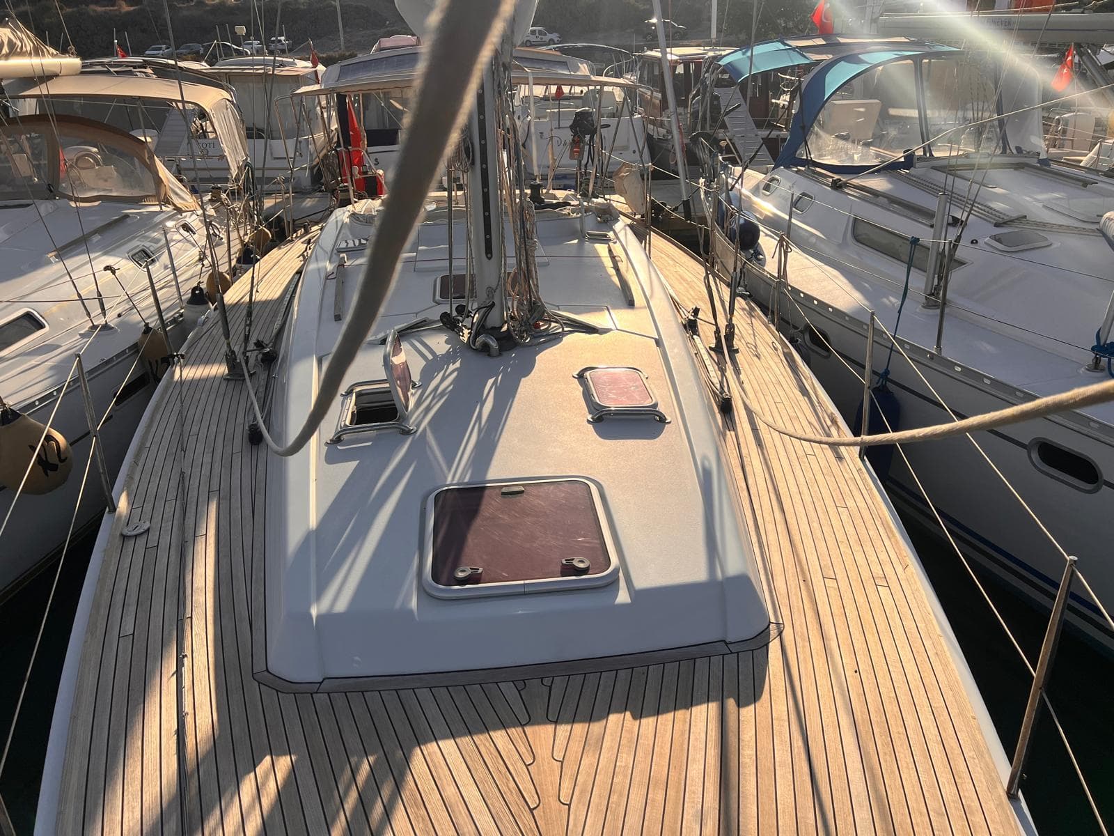 2007 Grand Soleil 43 sailboat deck, docked among other boats in a marina.
