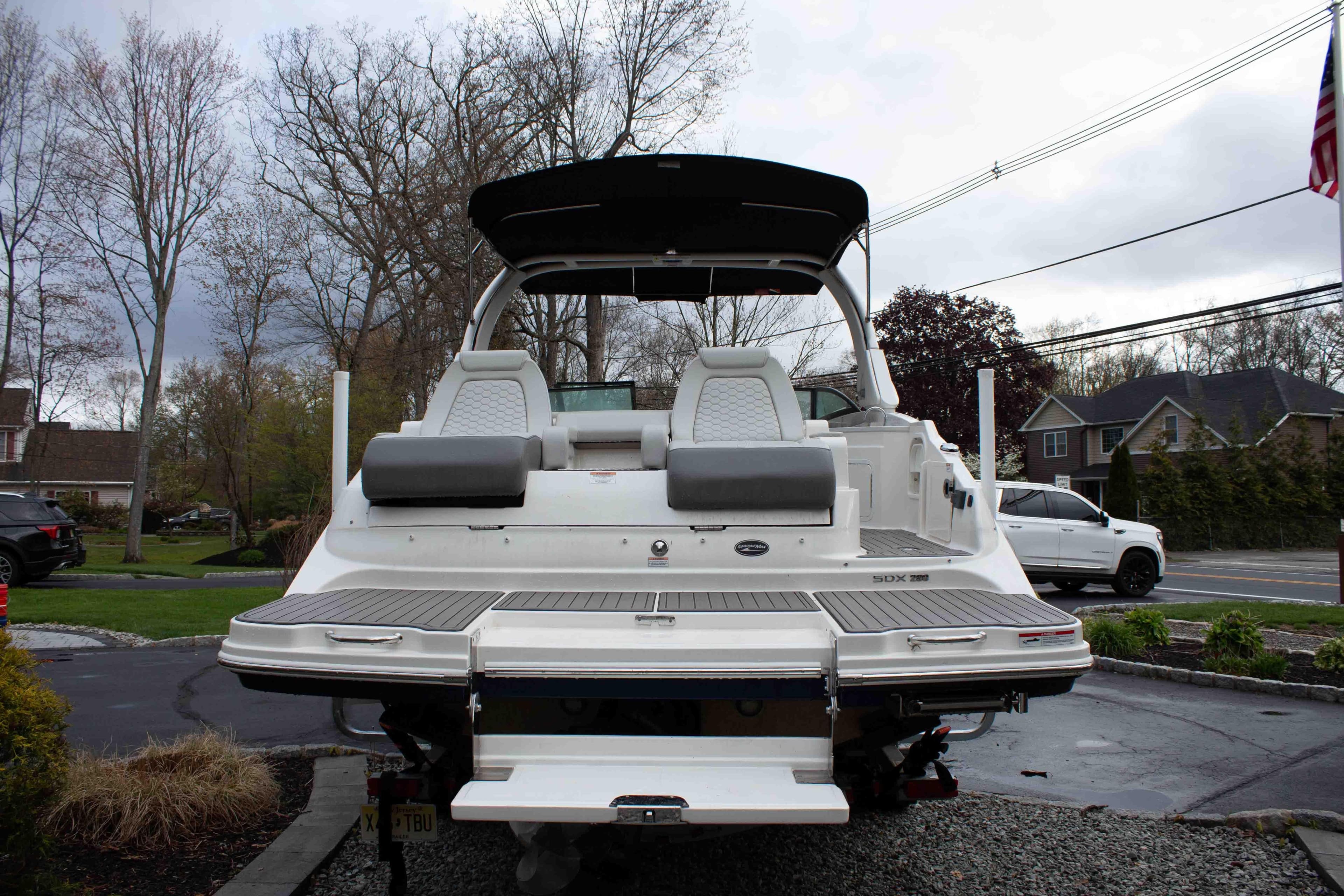 2024 Sea Ray SDX 290 boat with spacious deck and seating, parked outdoors.