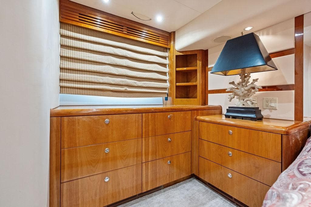 Luxurious wooden cabinetry and lamp in 2006 Hatteras 68 Convertible yacht interior.