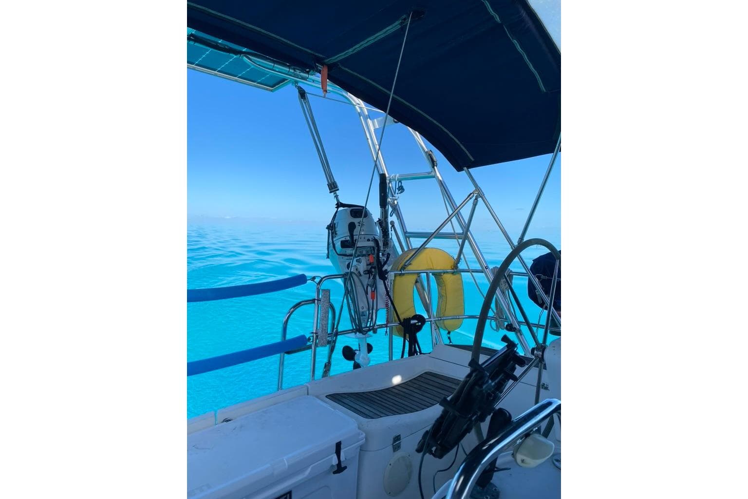 Cockpit view of 2006 Jeanneau Sun Odyssey 45 sailing on clear blue waters.