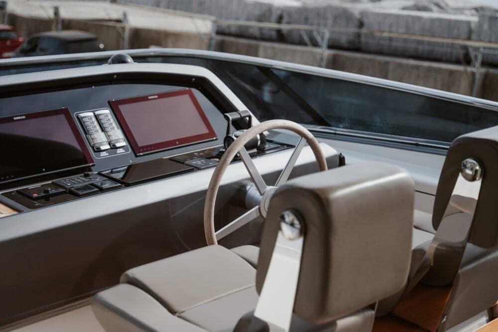 Helm of 2016 Sanlorenzo SL86 yacht with modern controls and leather seating.