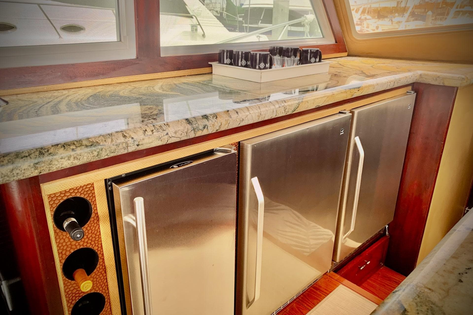 1984 Egg Harbor 48' Flybridge interior with granite countertop, stainless steel appliances, and wine storage.