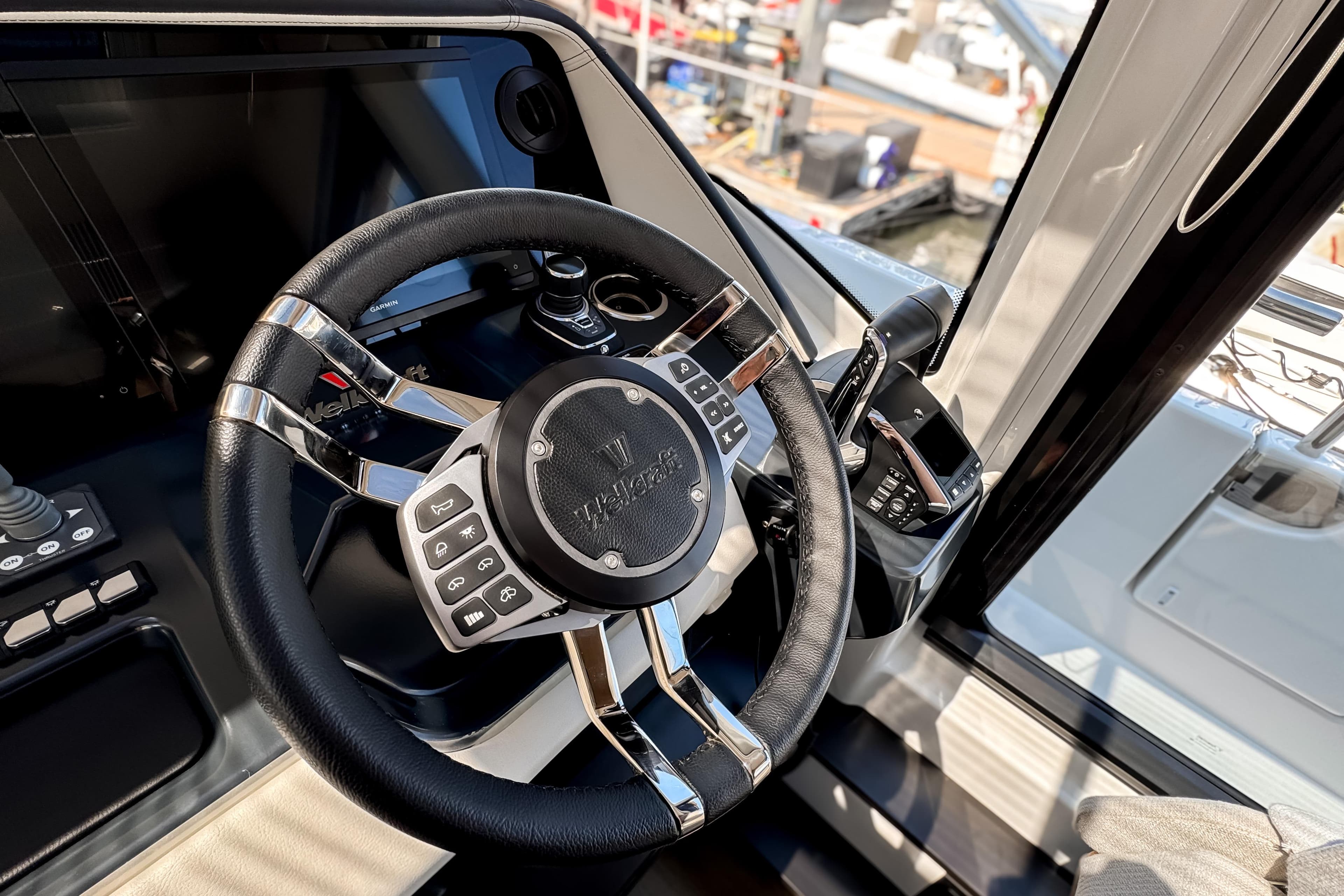 Steering wheel of 2026 Wellcraft 44 Explorer yacht, featuring modern controls and sleek design.