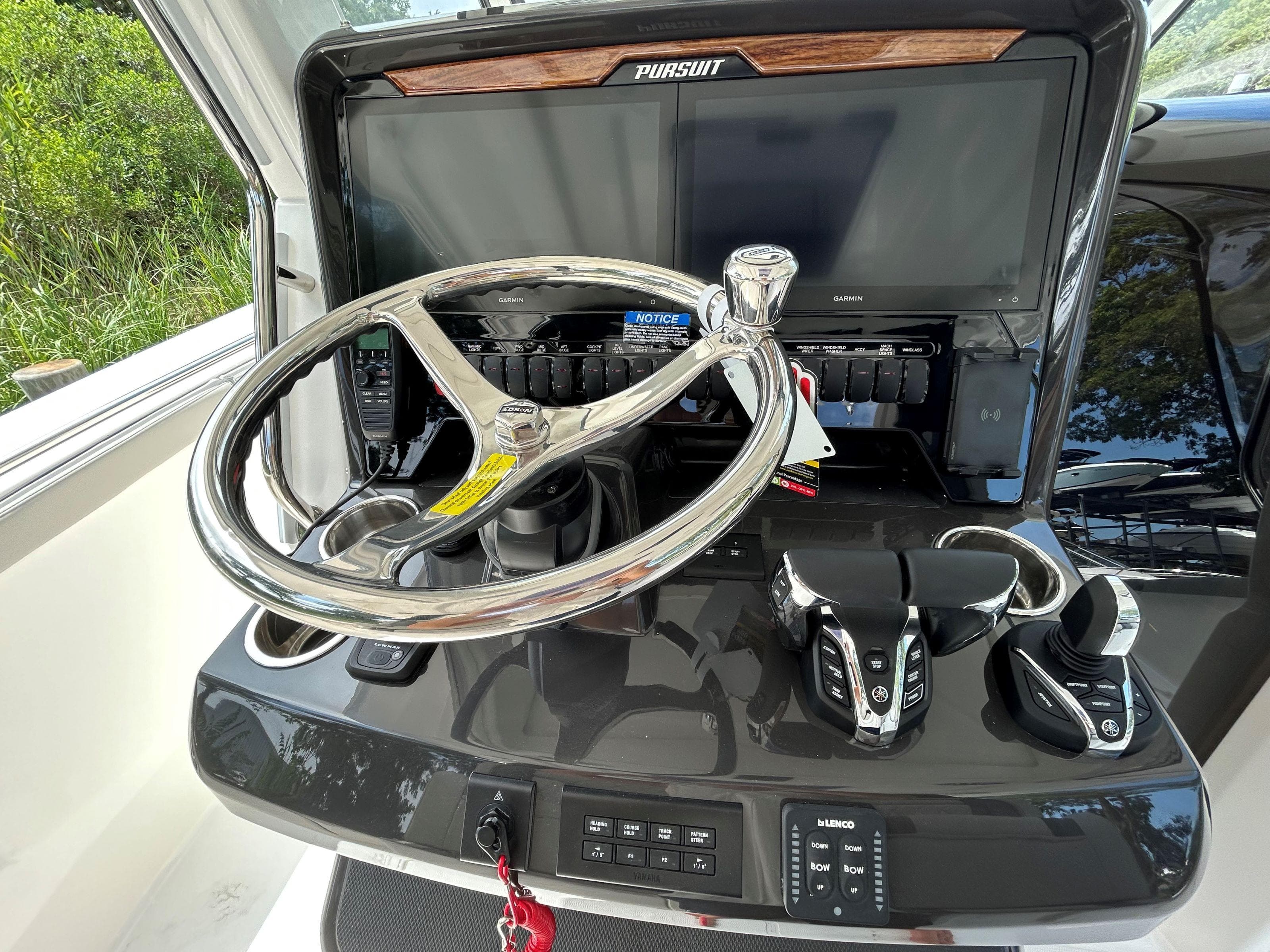 2026 Pursuit S 328 boat helm with steering wheel and control panel.