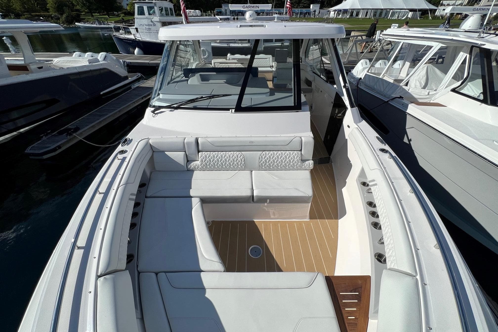 2026 Regal LX43 boat with spacious seating and modern design, docked at a marina.
