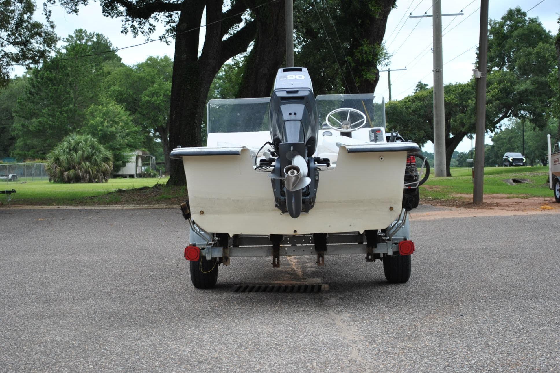 1999 Carolina Skiff 19 Classic boat on trailer, rear view with outboard motor.