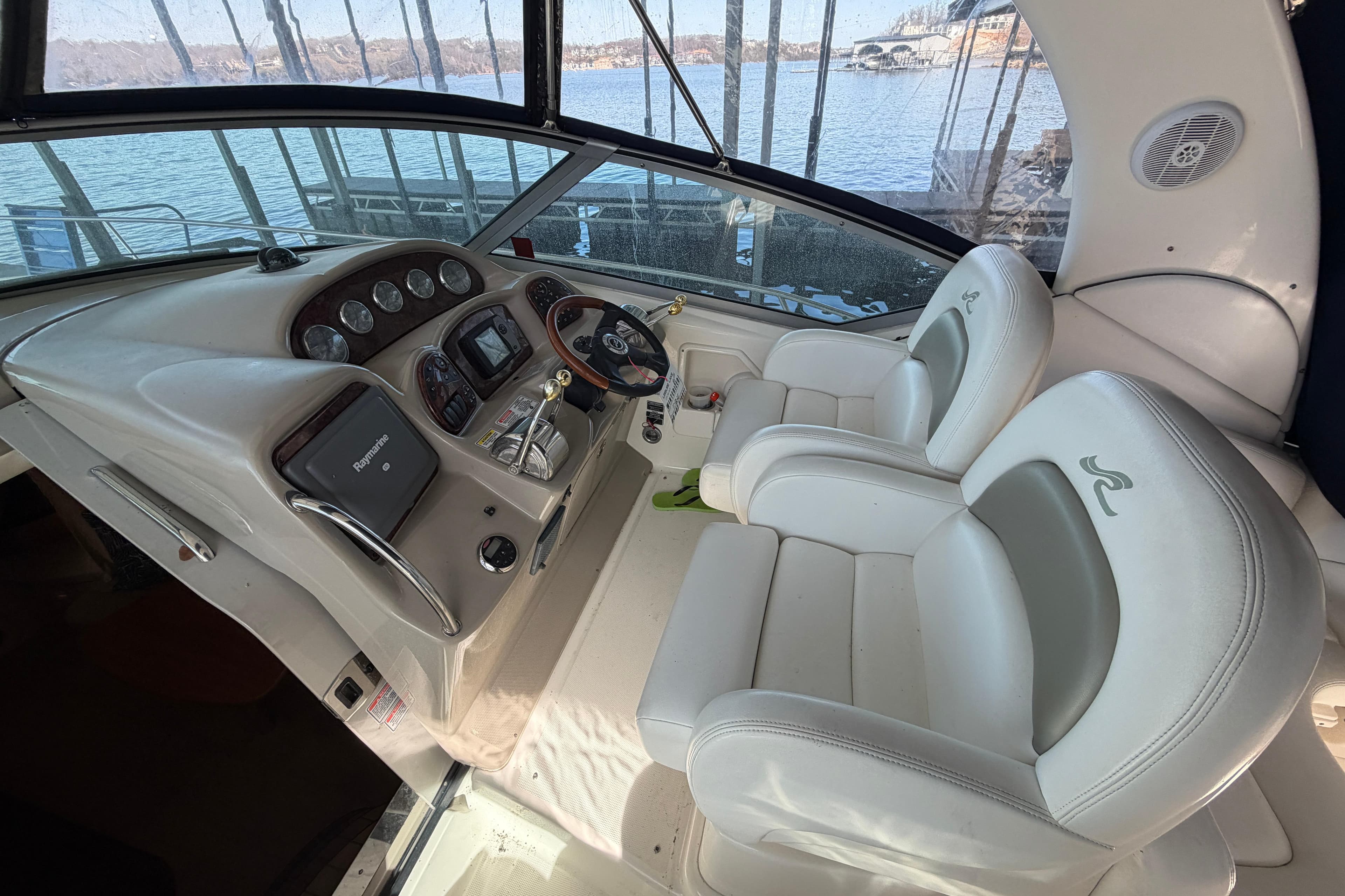 Interior cockpit of 2006 Sea Ray 340 Sundancer boat with steering wheel and controls.