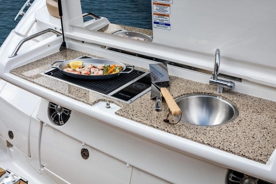 Manufacturer Provided Image: Outdoor kitchen on 2021 Sea Ray Sundancer 350 Coupe yacht with grill and sink.