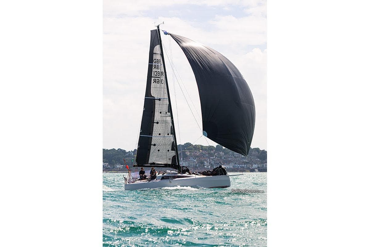 2022 Dehler 30 one design sailboat with black sails on open water.