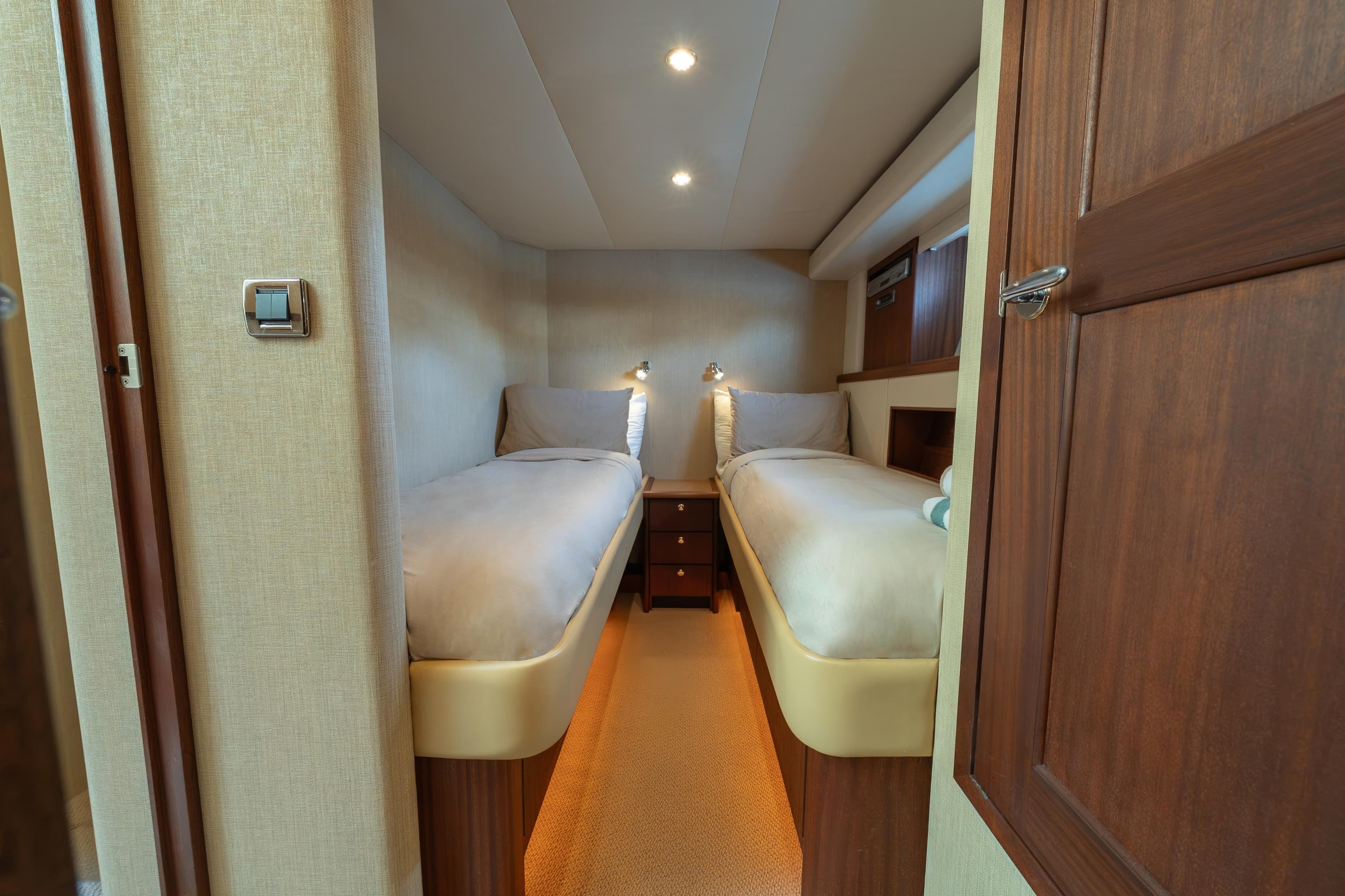 2007 Pacific Mariner Pilothouse cabin with twin beds and wooden interior.